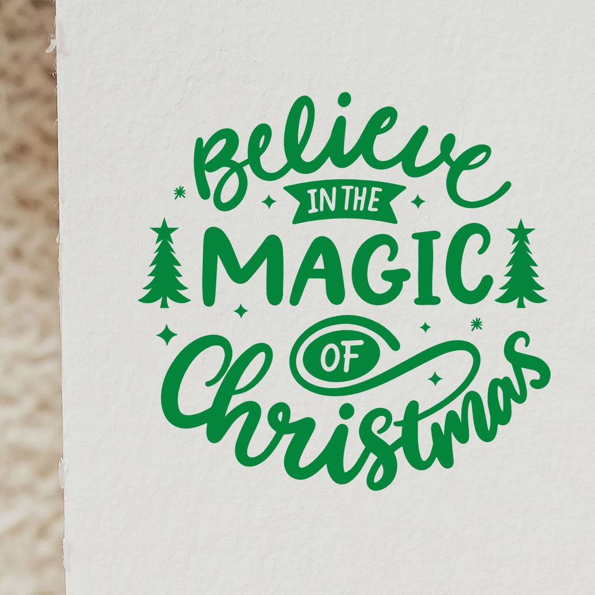 Believe in the Magic of Christmas rubber stamp design with green script, trees, and stars for holiday crafting.