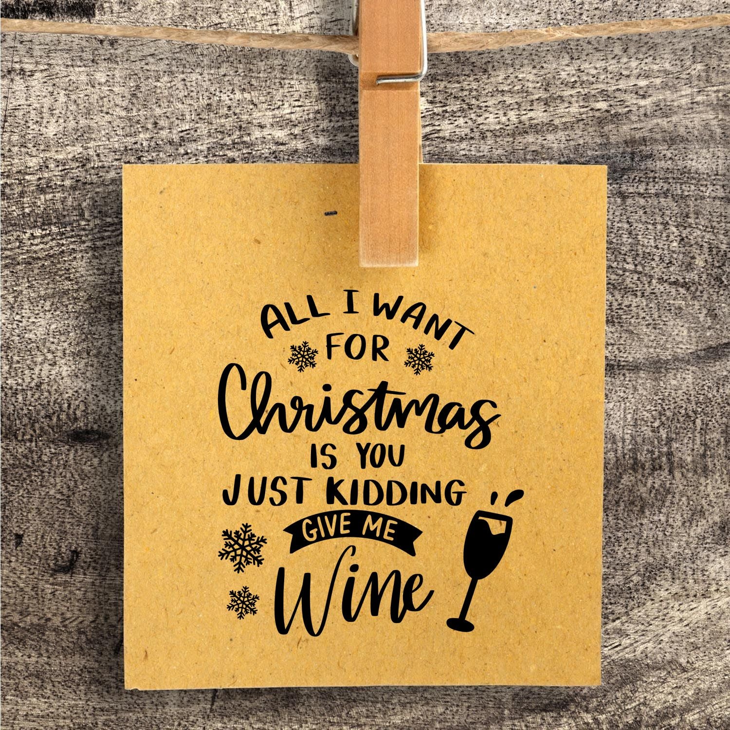 Christmas wine rubber stamp on kraft gift tag reads All I want for Christmas is you give me wine with snowflakes and wine glass.