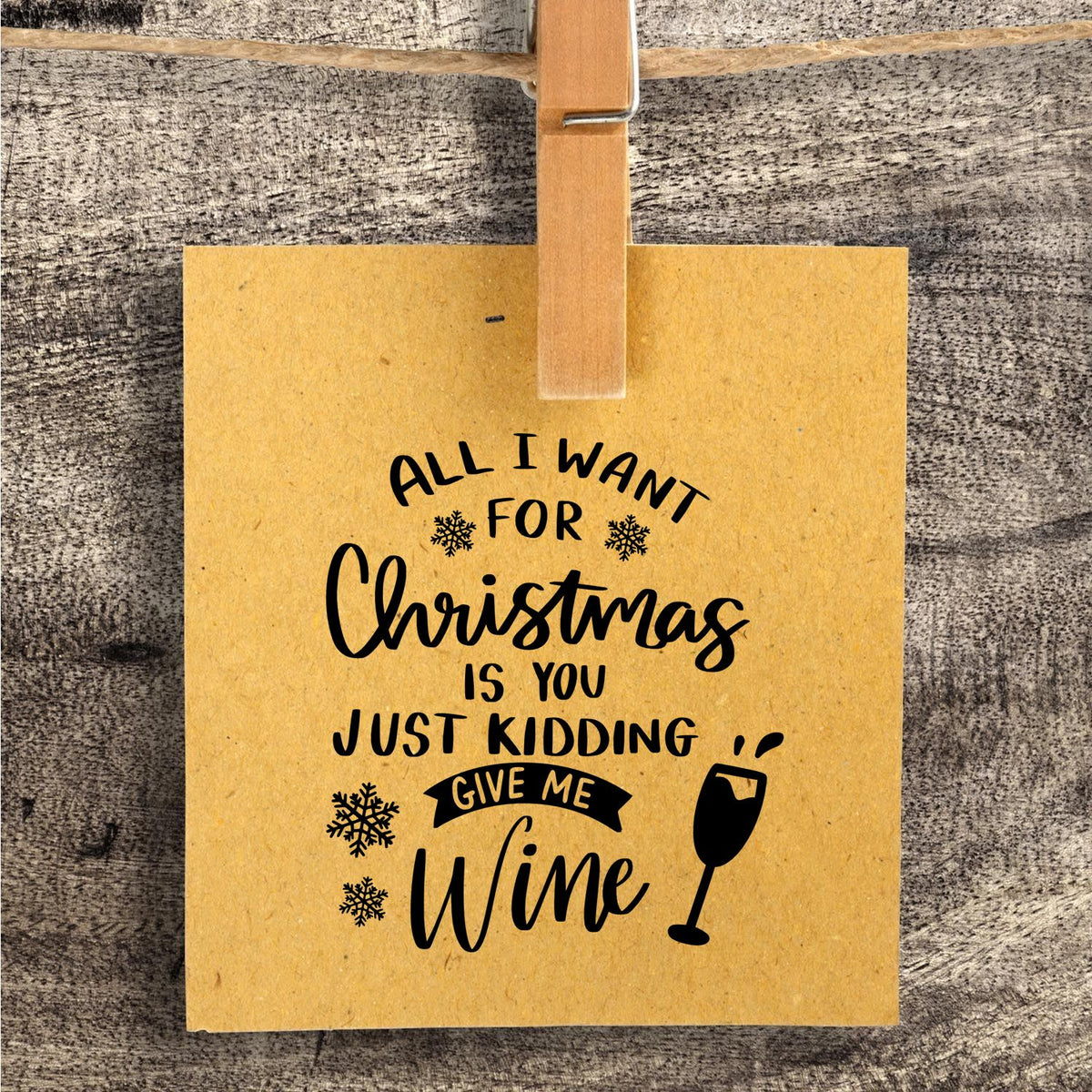 Slim Pre-Inked All I Want For Christmas Is You Just Kidding Give Me Wine Stamp imprint stamped in black ink. “All I Want for Christmas Is You Just Kidding Give Me Wine” appears with snowflakes and a wineglass.
