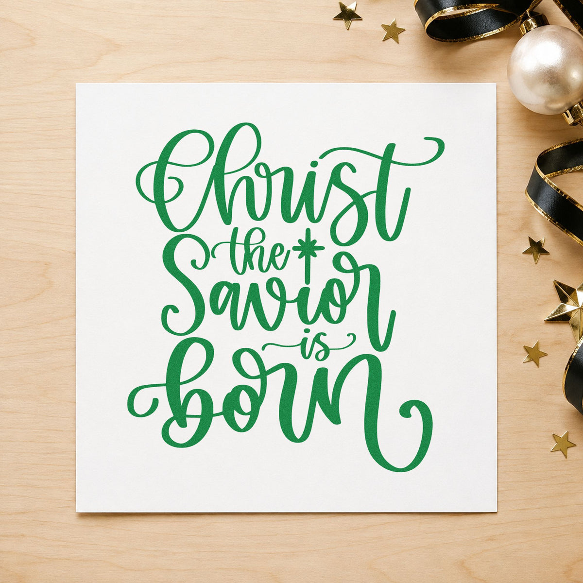 Christ The Savior Is Born craft stamp imprinted in green ink on paper, a design suited to framed vestry wall.