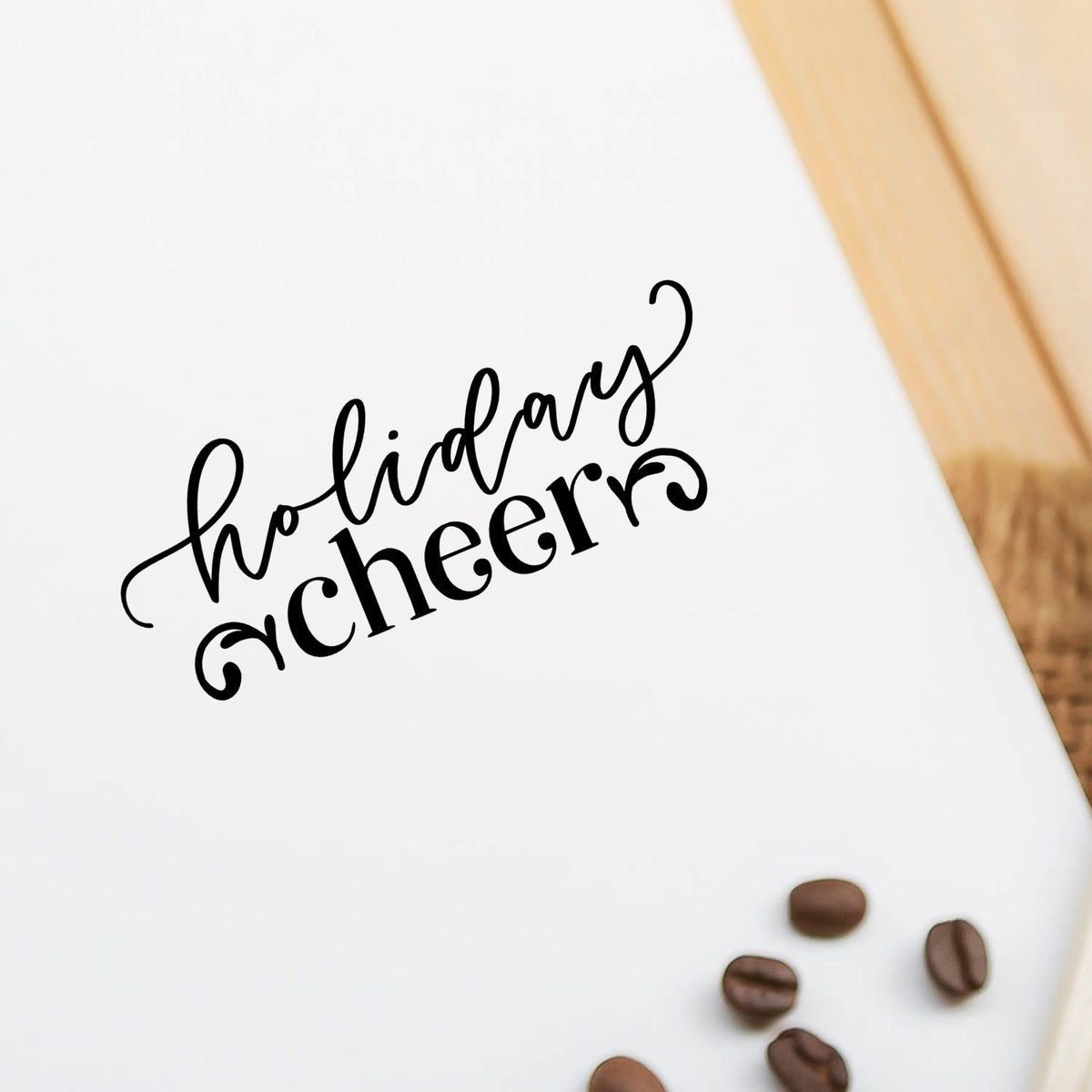 Holiday cheer rubber stamp on paper for festive cards, packaging, and DIY crafts.