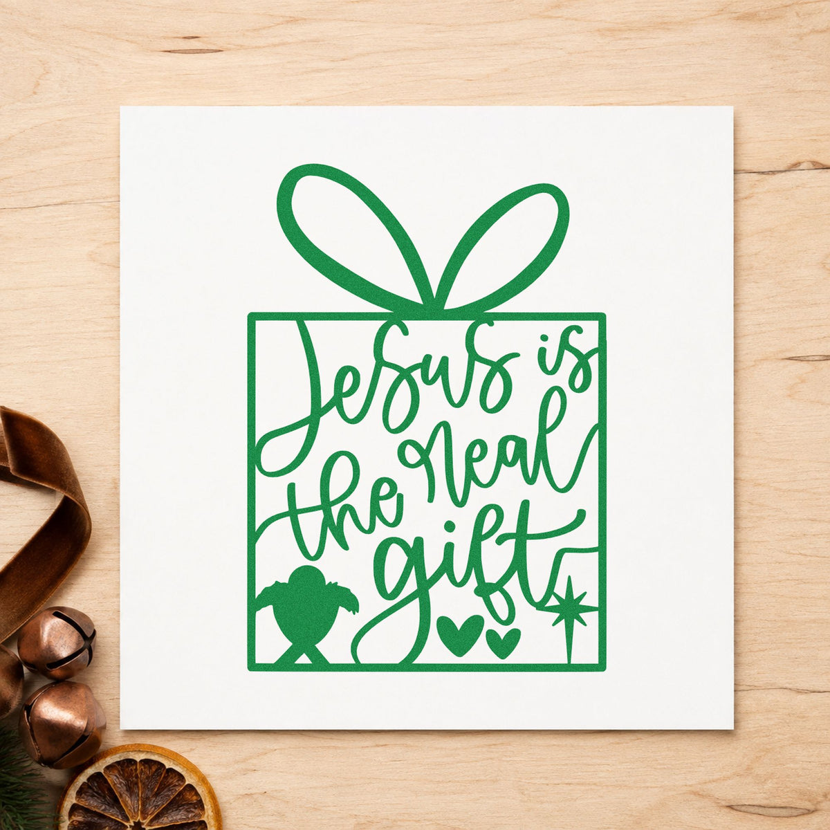 Jesus Is The Real Gift craft stamp imprint in green ink on a handmade project, one idea being outreach event flyers.