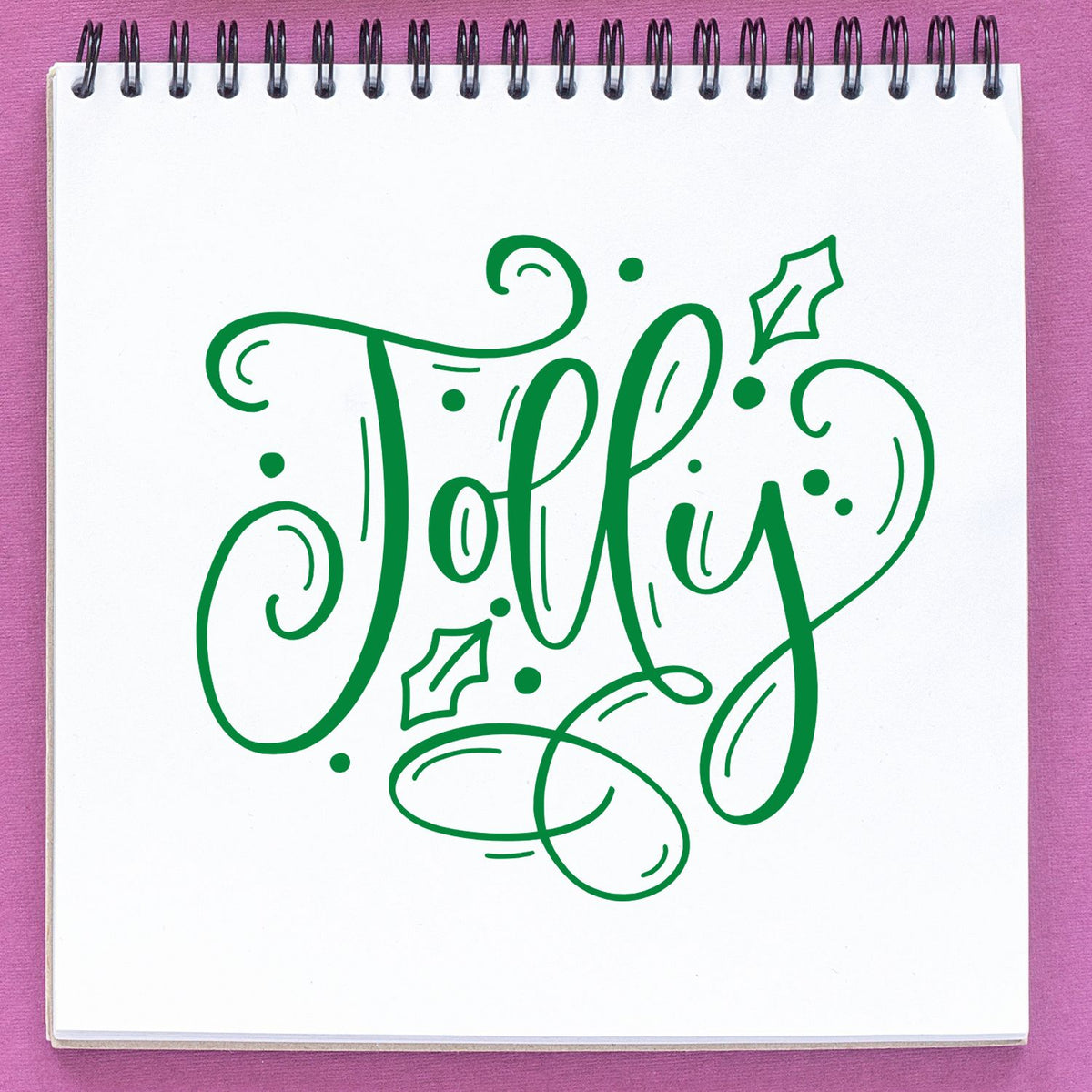 Jolly holiday rubber stamp design in festive script with holly accents, perfect for Christmas cards and seasonal crafts.
