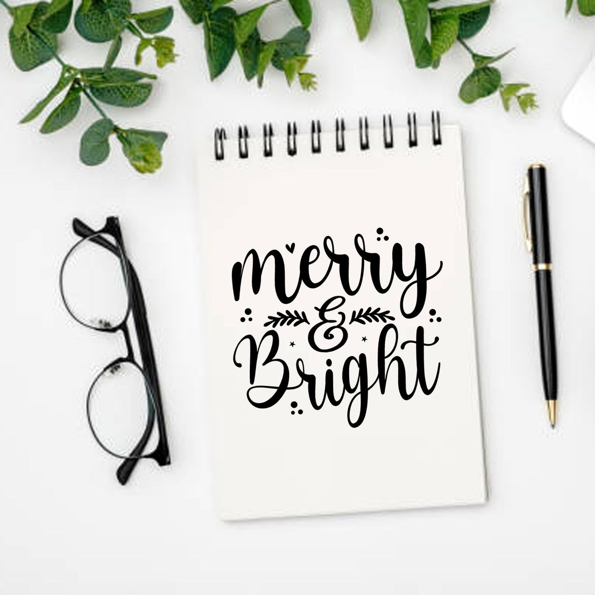 Merry and Bright Christmas rubber stamp design on a notebook, perfect for holiday cards, crafts, and festive planner decor.
