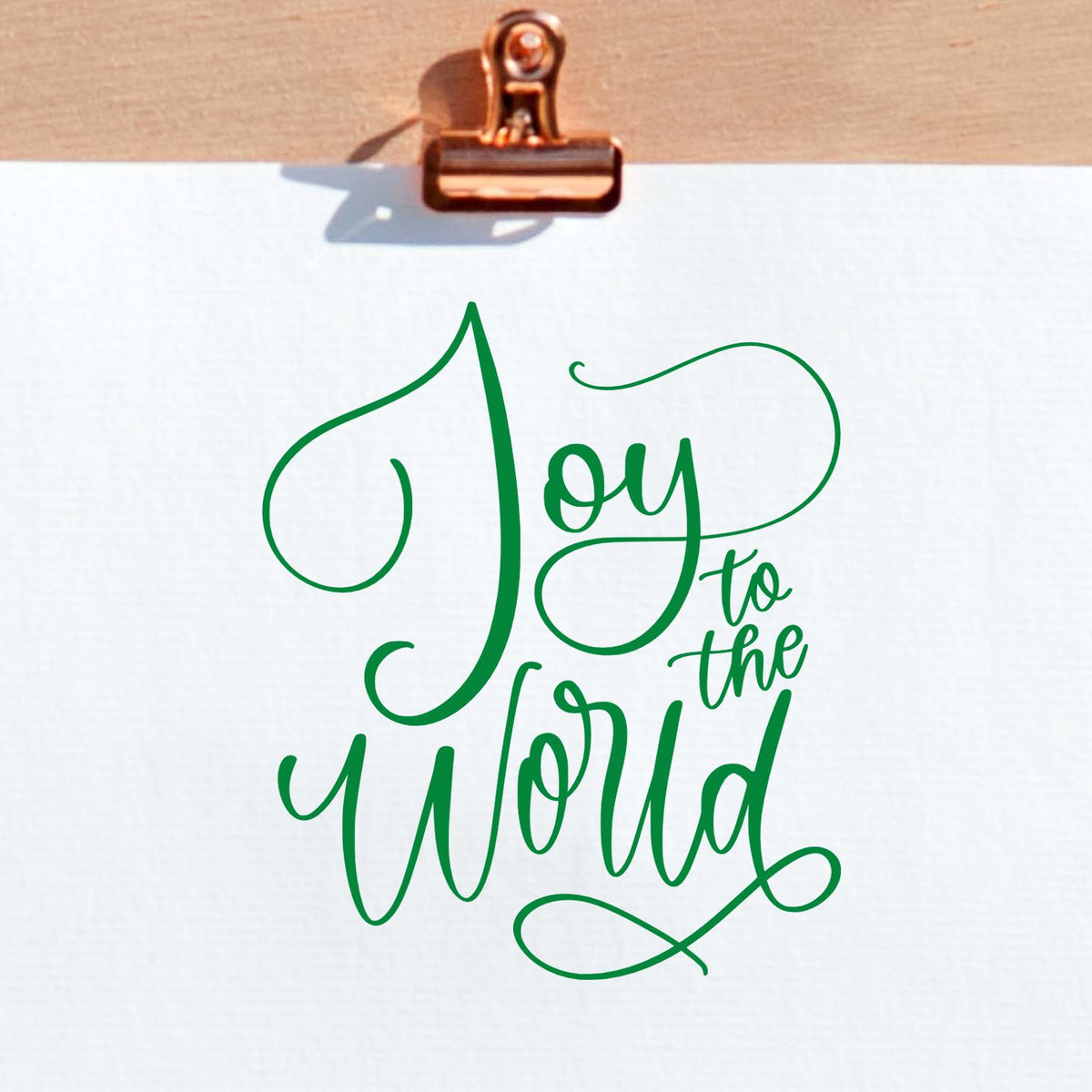 Joy to the World Christmas rubber stamp design in elegant green script, perfect for holiday cards and festive crafts.