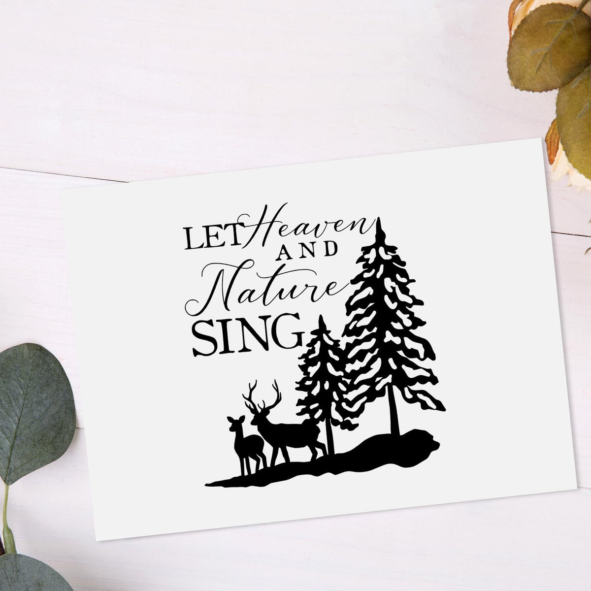 Heaven Nature Sing Deer Slim Pre-Inked Stamp imprint stamped in black ink. “Let Heaven and Nature Sing” appears beside snow-covered pines and a deer silhouette.