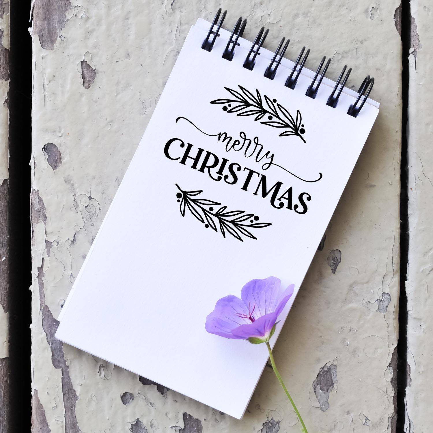 Merry Christmas rubber stamp mockup with floral accents for holiday cards