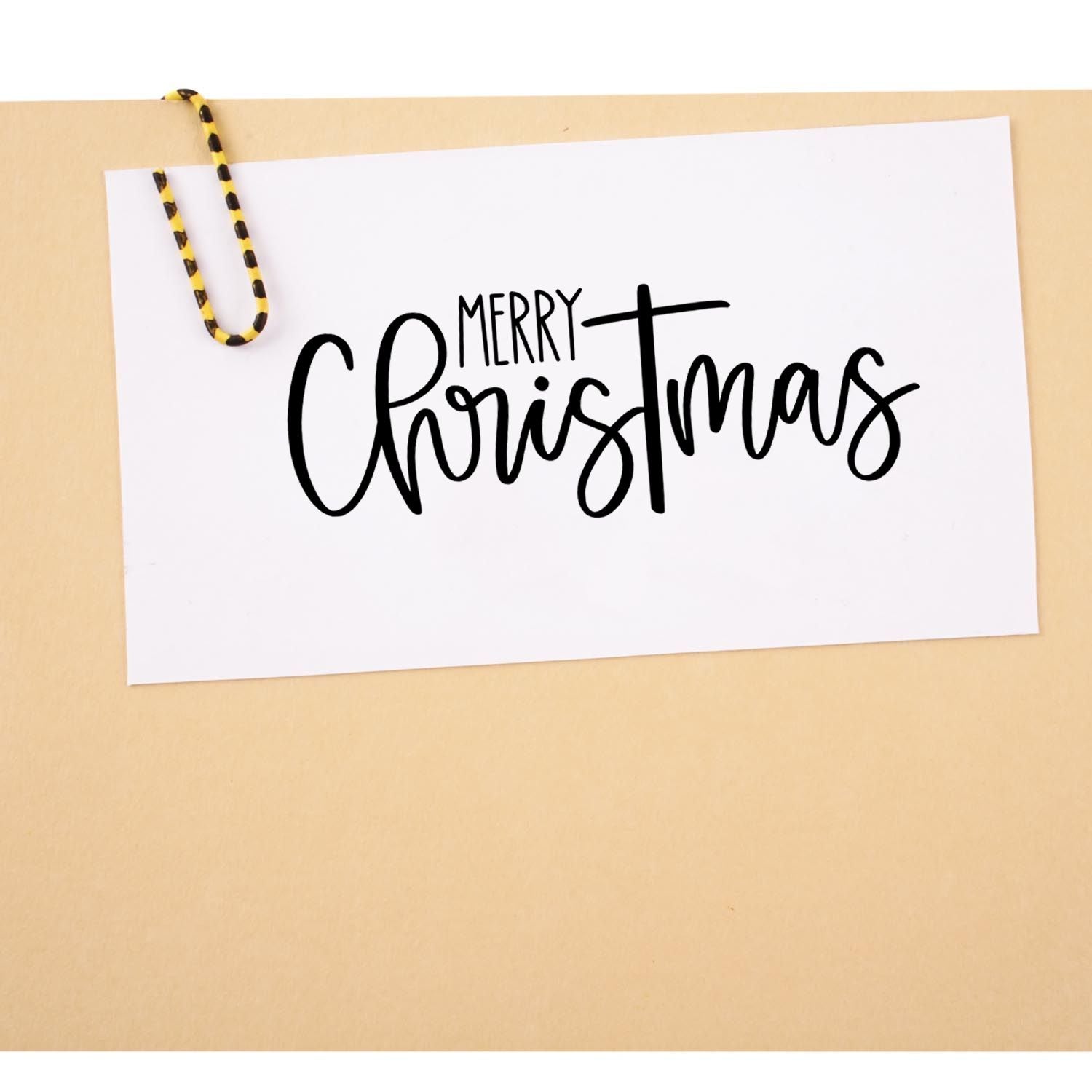 Merry Christmas rubber stamp in black script on white card, perfect for holiday cards, handmade crafts and gift tags.