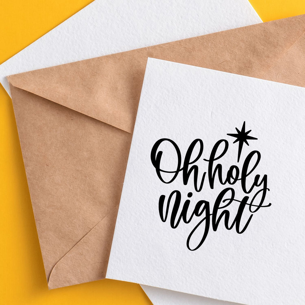 Holiday greeting card with Oh Holy Night script rubber stamp on white card over kraft envelope.