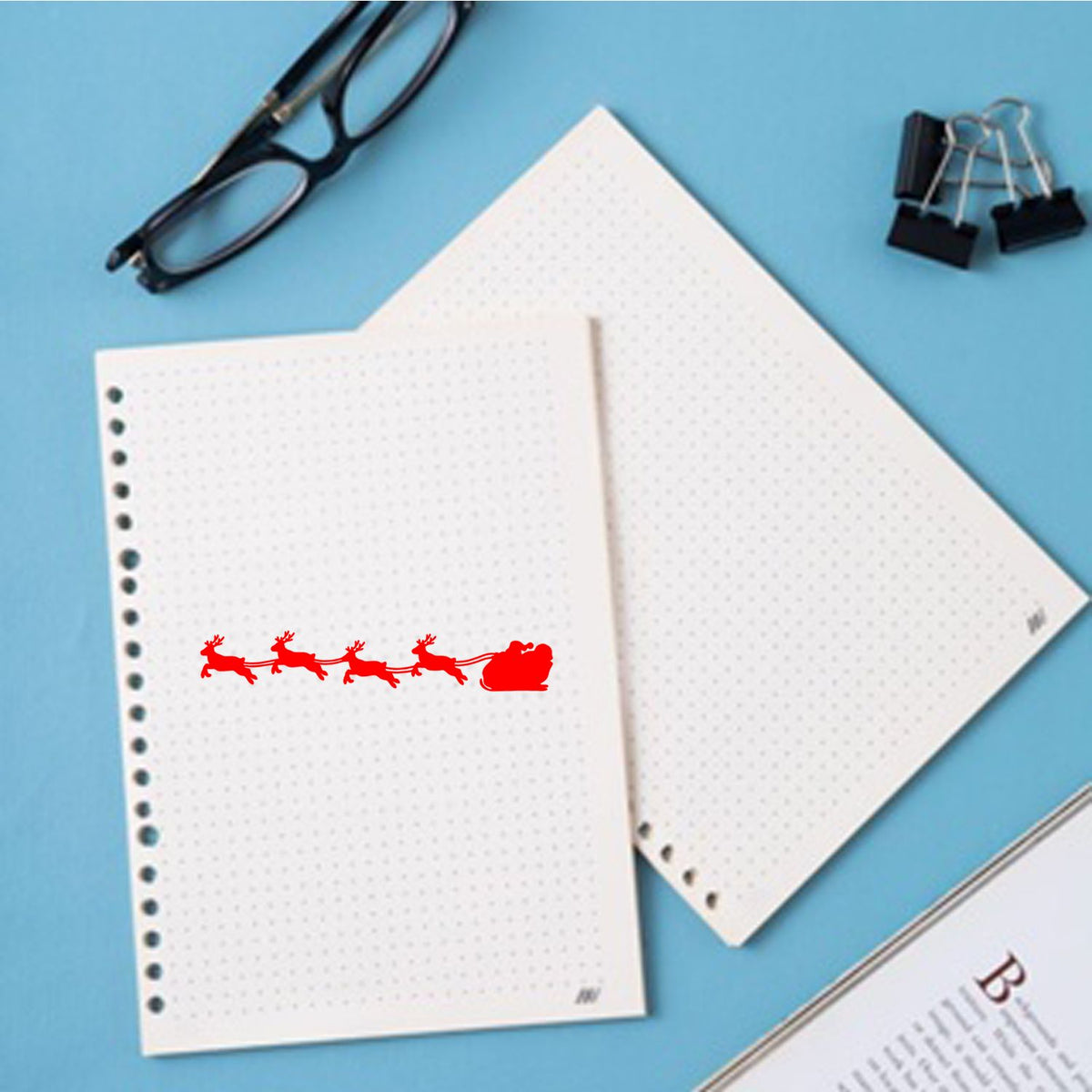 Christmas Santa sleigh reindeer rubber stamp on notebook paper, ideal for holiday card crafting and scrapbooking.