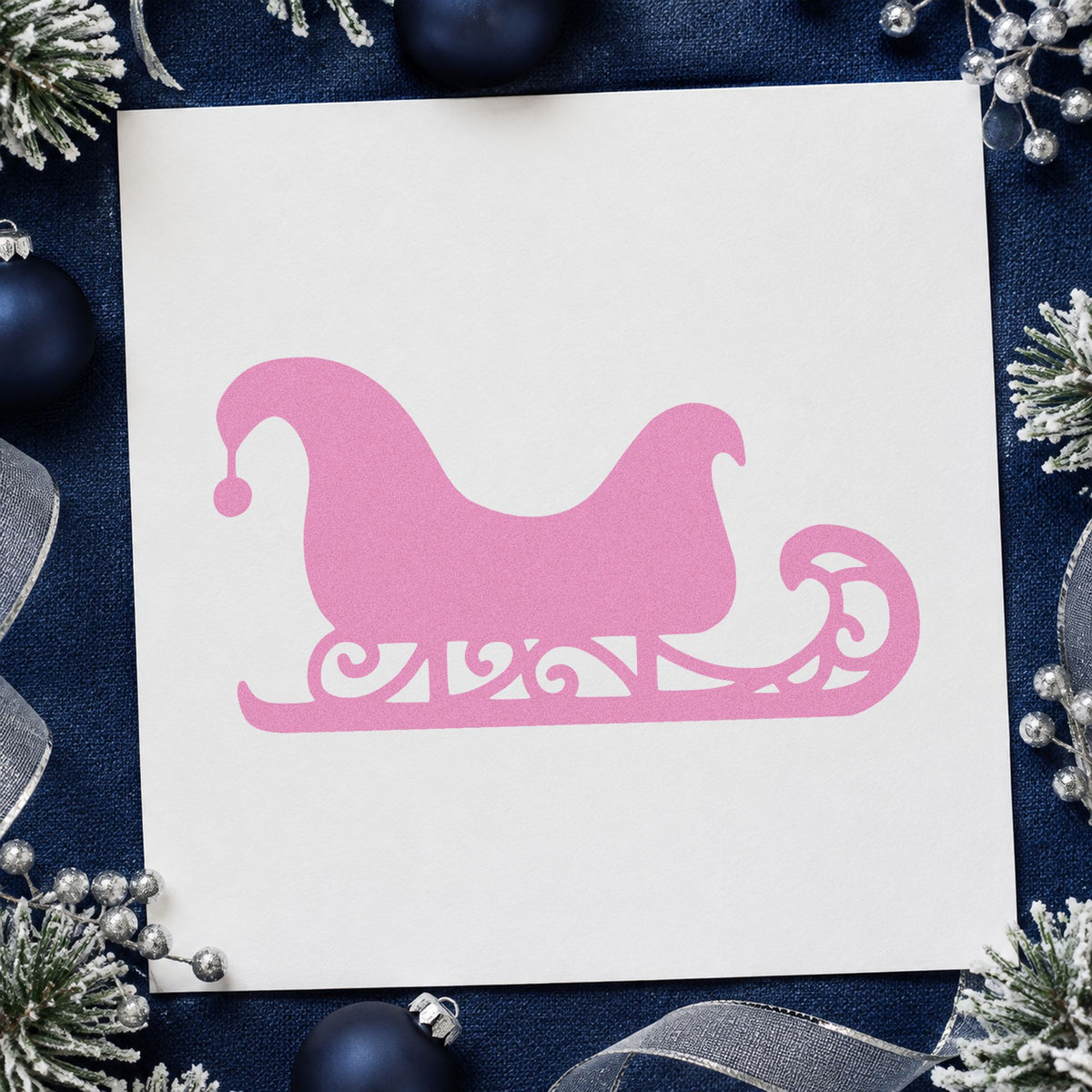 Decorative Santa Sleigh craft stamp in purple ink on cardstock, an easy option for repeat motif paper.