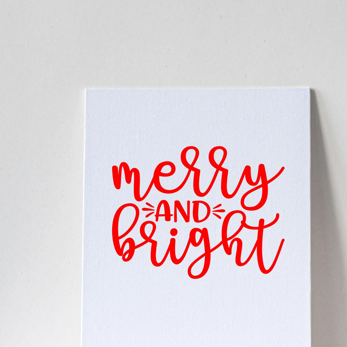 Merry and bright red script rubber stamp design on white card, perfect for Christmas cards and holiday crafting.