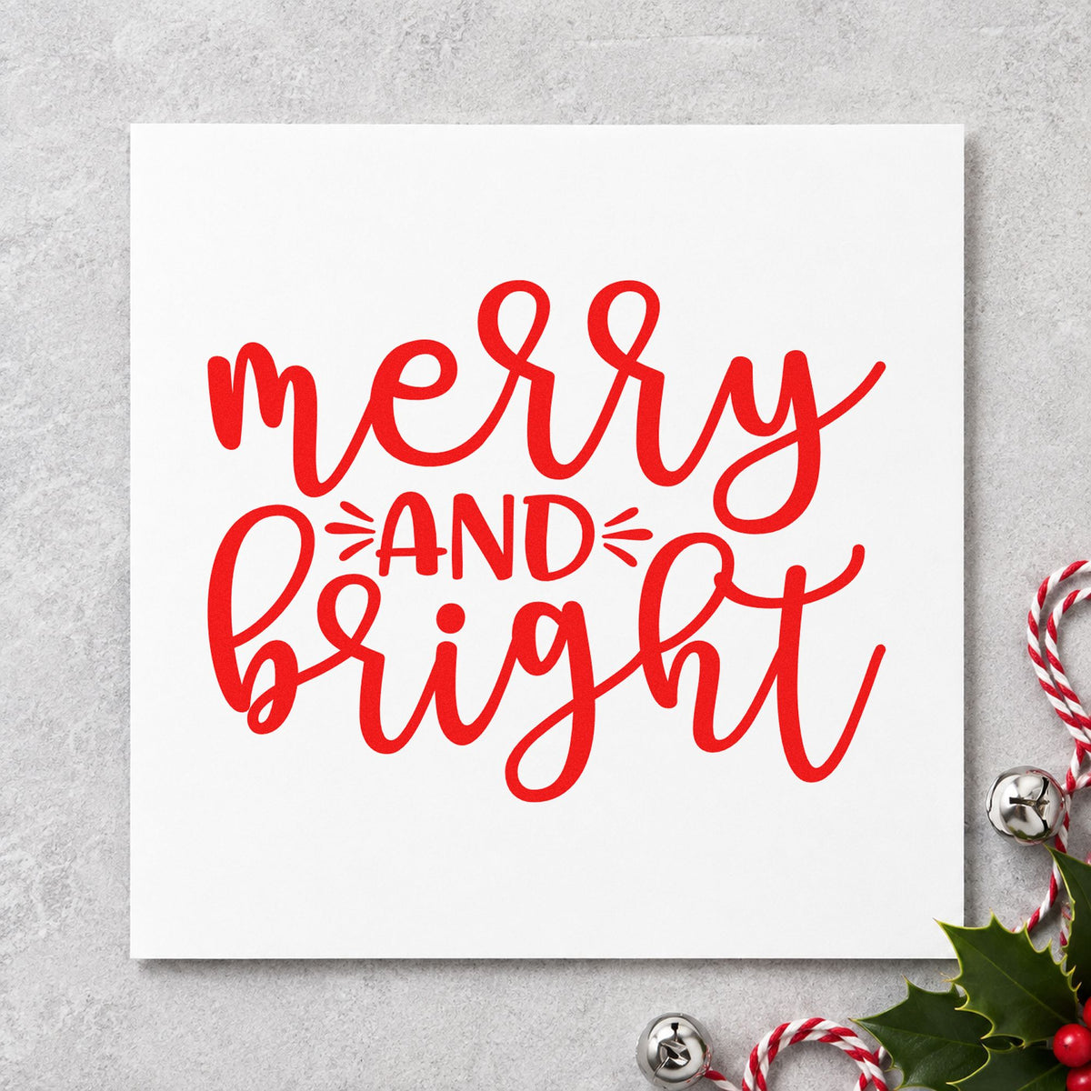 Merry And Bright Script craft stamp in red ink on cardstock, an easy option for counter cloth printing.