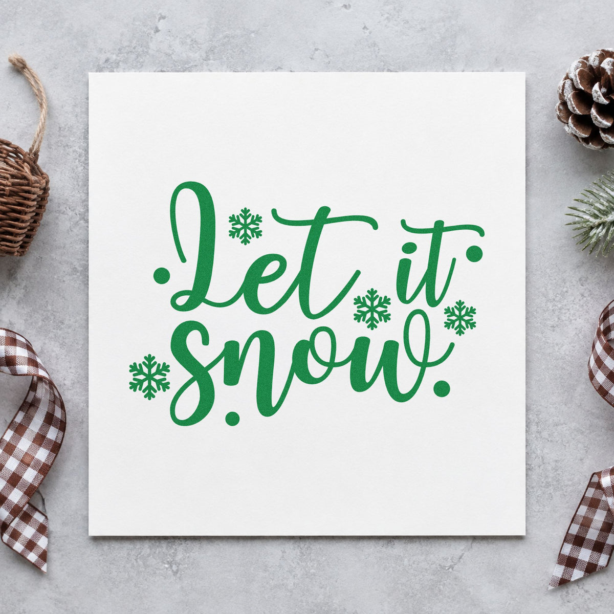 Let It Snow Snowflakes craft stamp imprint in green ink on a handmade project, one idea being skate bag gift tags.
