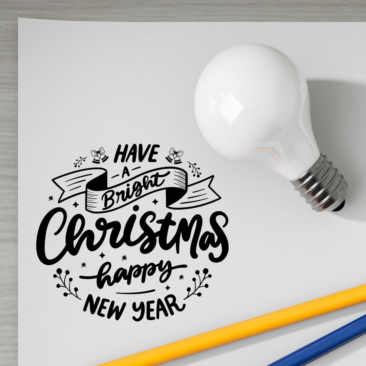Holiday rubber stamp design reading Have a Bright Christmas Happy New Year with festive light bulb graphic.