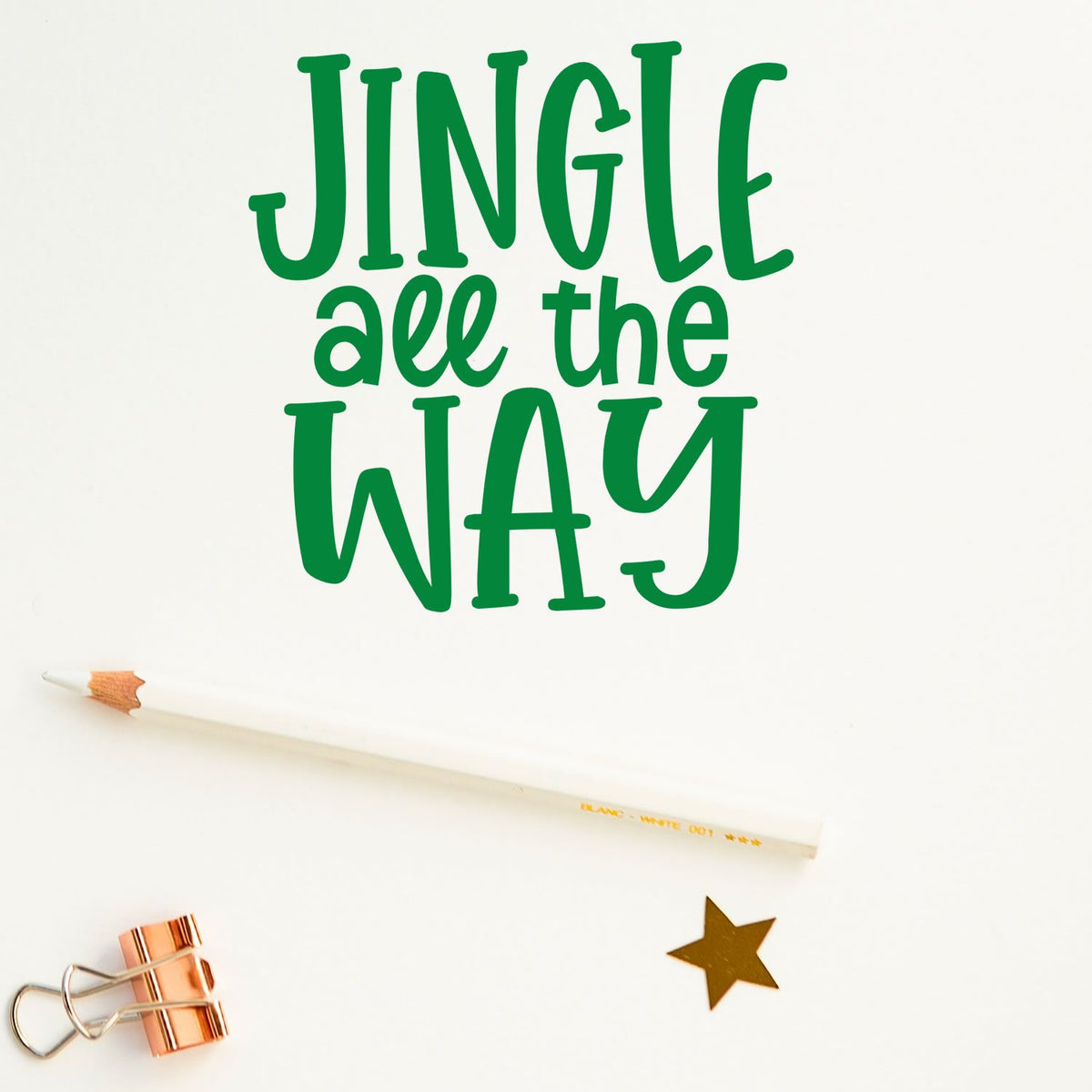 Jingle all the way Christmas rubber stamp design with green lettering, pencil, and star on a white craft background.