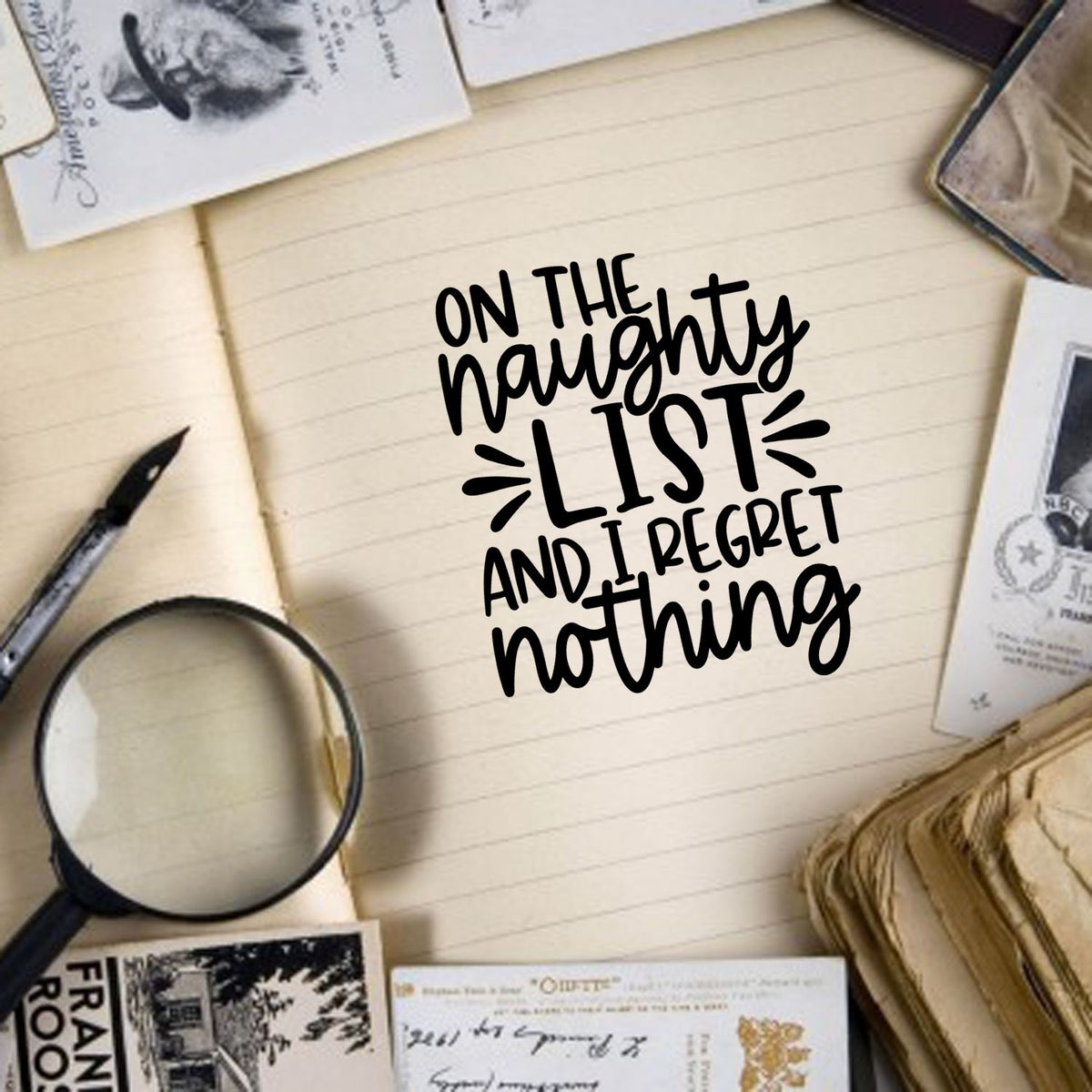 Naughty List Regret Nothing Lettering Pre-Inked Stamp – Slim imprint stamped in black ink. “On the Naughty List and I Regret Nothing” appears in mixed lettering with decorative rays.
