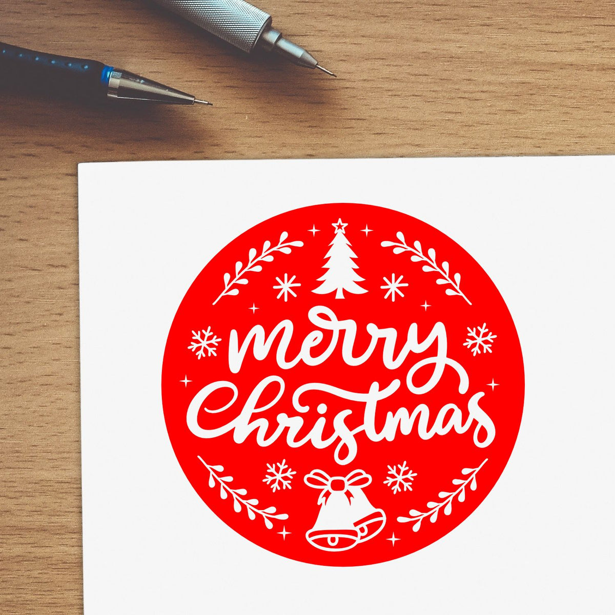 Merry Christmas rubber stamp design on paper with tree, bells and snowflakes for holiday cards and crafts