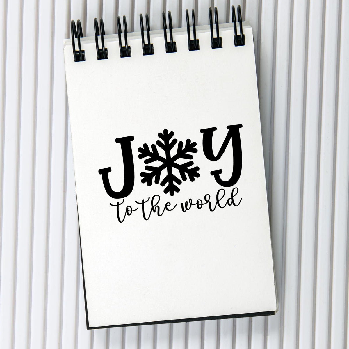 Christmas rubber stamp design with Joy to the World and snowflake, perfect for holiday cards, crafts, and scrapbooking.