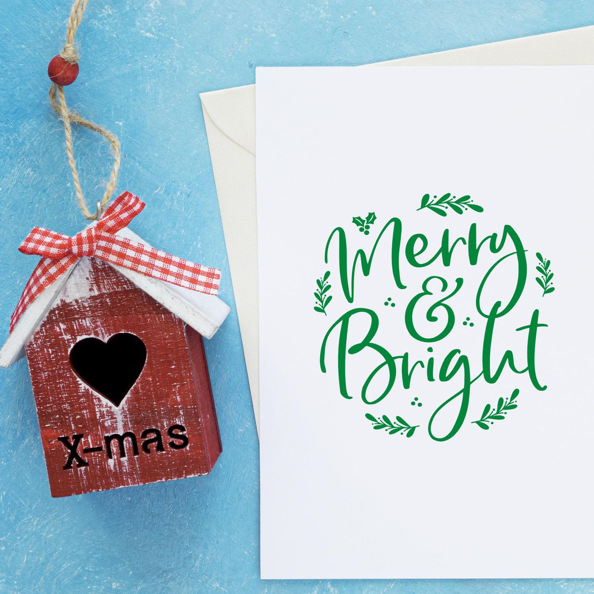 Merry & Bright Christmas rubber stamp design for handmade holiday cards, featuring festive green calligraphy and holly accents.