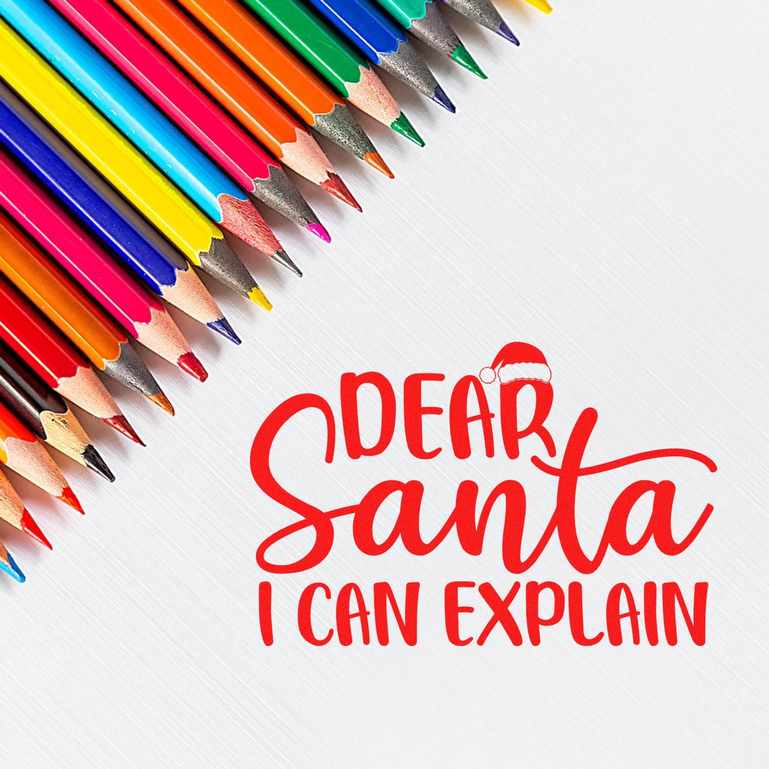 Christmas rubber stamp design reading Dear Santa I Can Explain in festive red lettering with Santa hat.