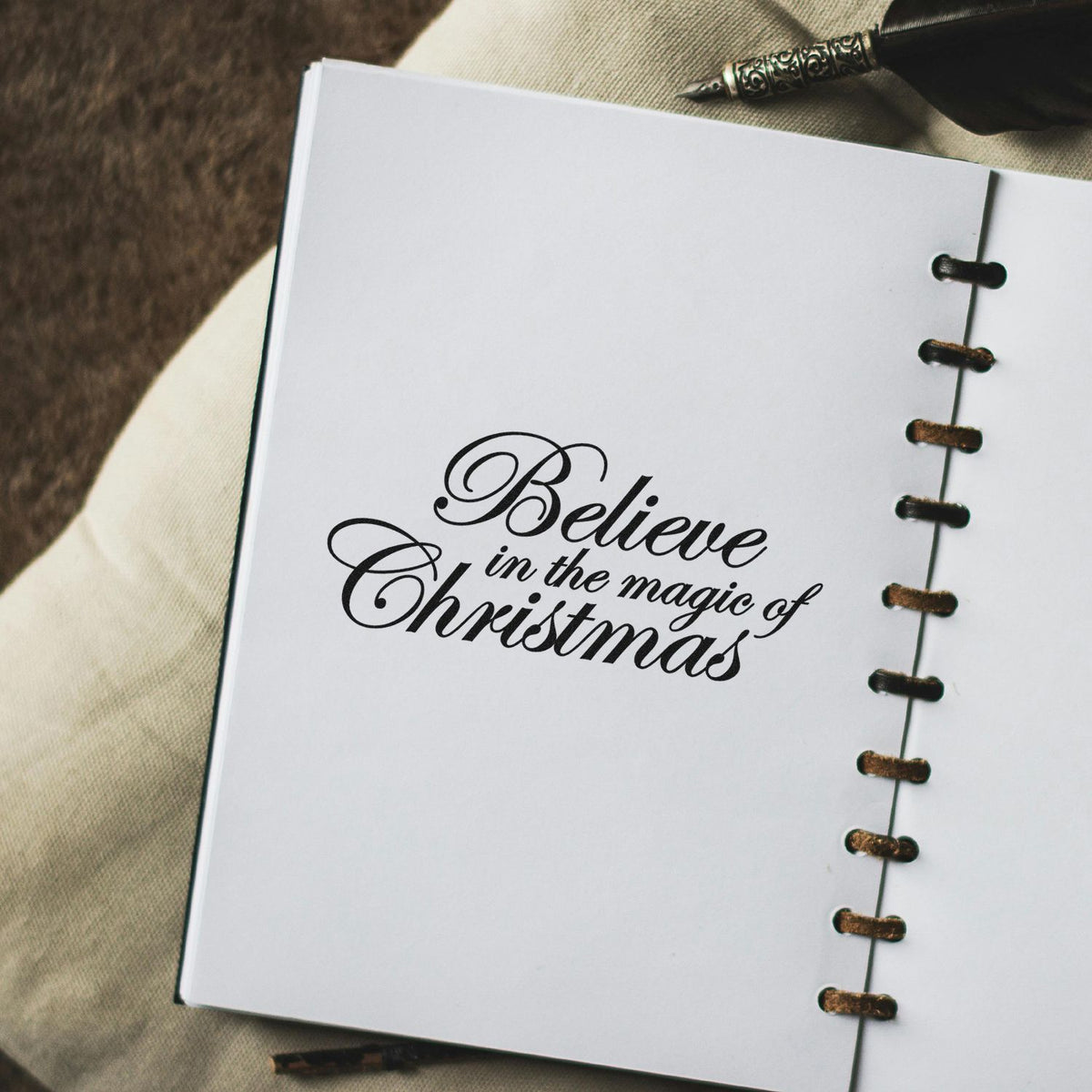 Slim Pre-Inked Believe In The Magic Of Christmas Stamp imprint stamped in black ink. “Believe in the Magic of Christmas” appears in elegant slanted script.