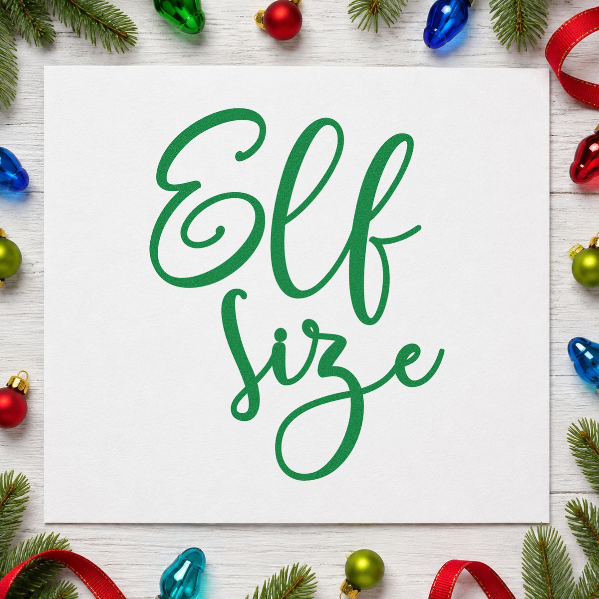 Elf Size Script craft stamp imprinted in green ink on paper, a design suited to framed playhouse door.