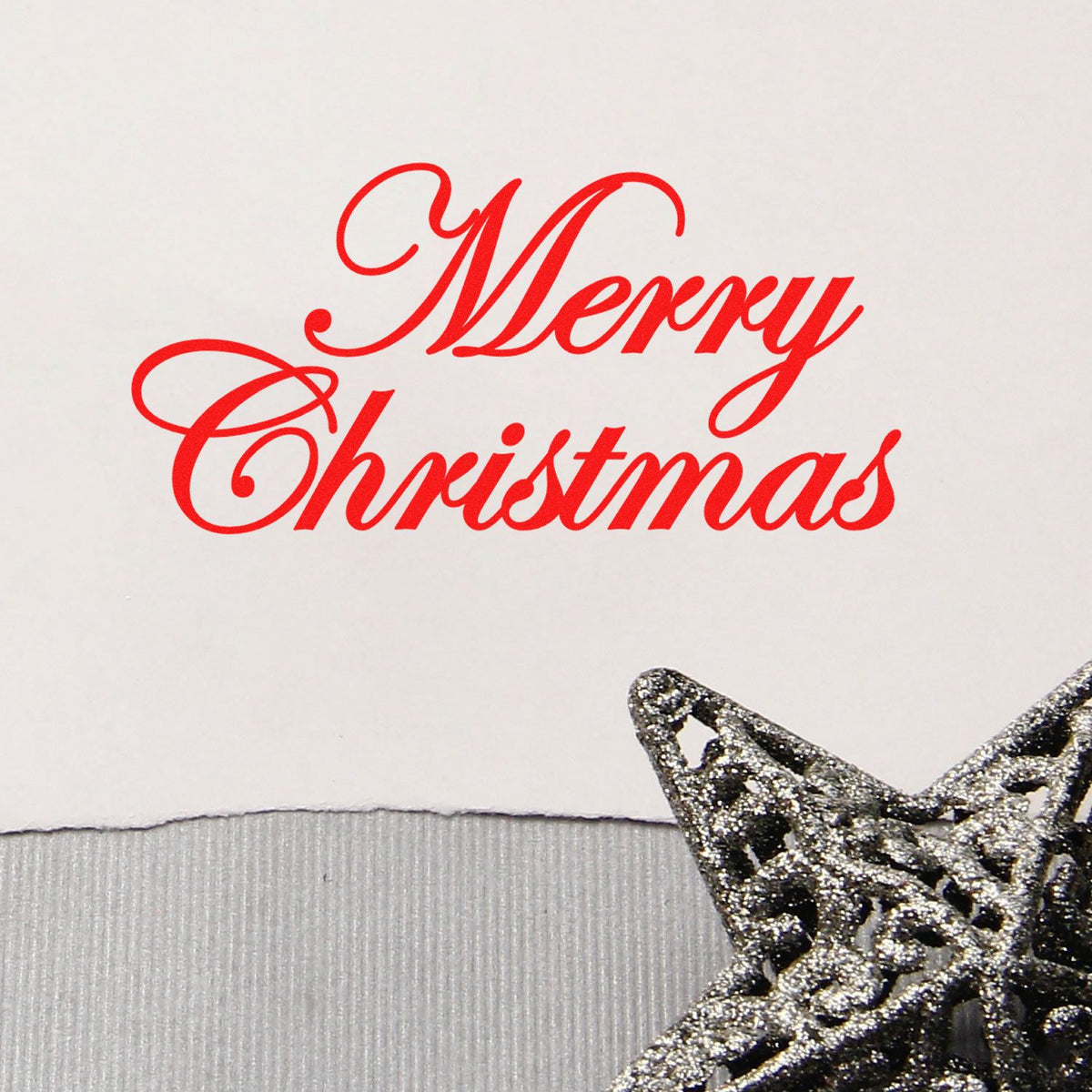 Merry Christmas rubber stamp in elegant red script, ideal for holiday cards and festive handmade paper crafts.