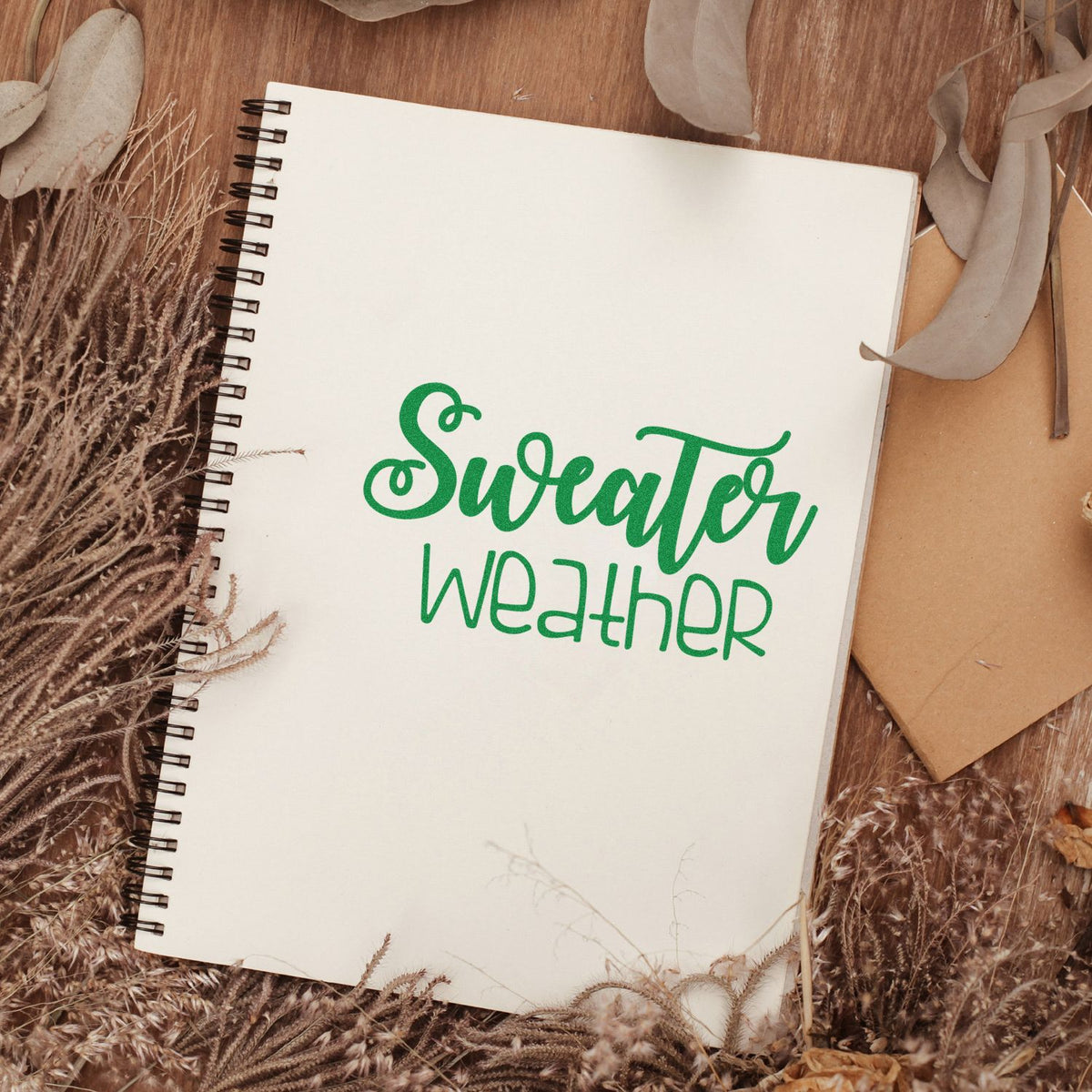 Sweetheart Weather rubber stamp design on a spiral notebook, styled with dried florals for rustic stationery and scrapbooking.