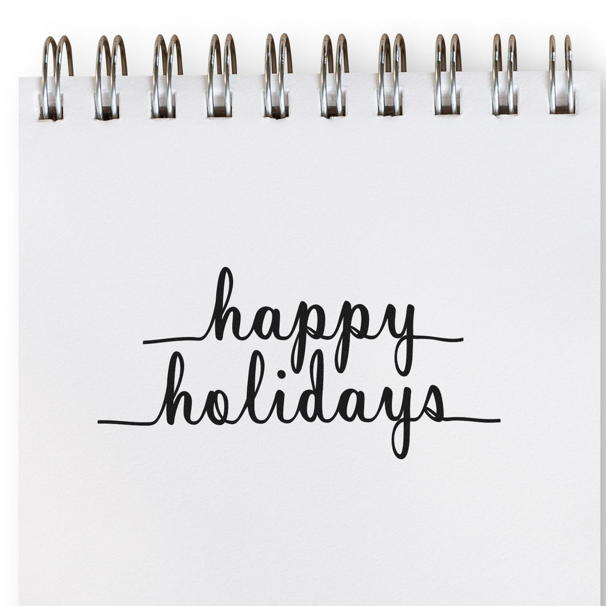 Happy Holidays rubber stamp design in elegant script on a spiral notebook page for seasonal cards, gifts, and packaging.