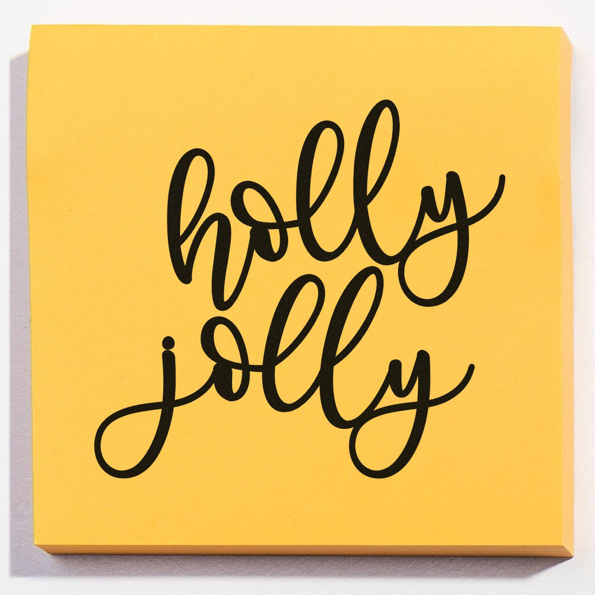Holly jolly rubber stamp design in bold cursive for Christmas cards, gift tags, and festive craft projects.