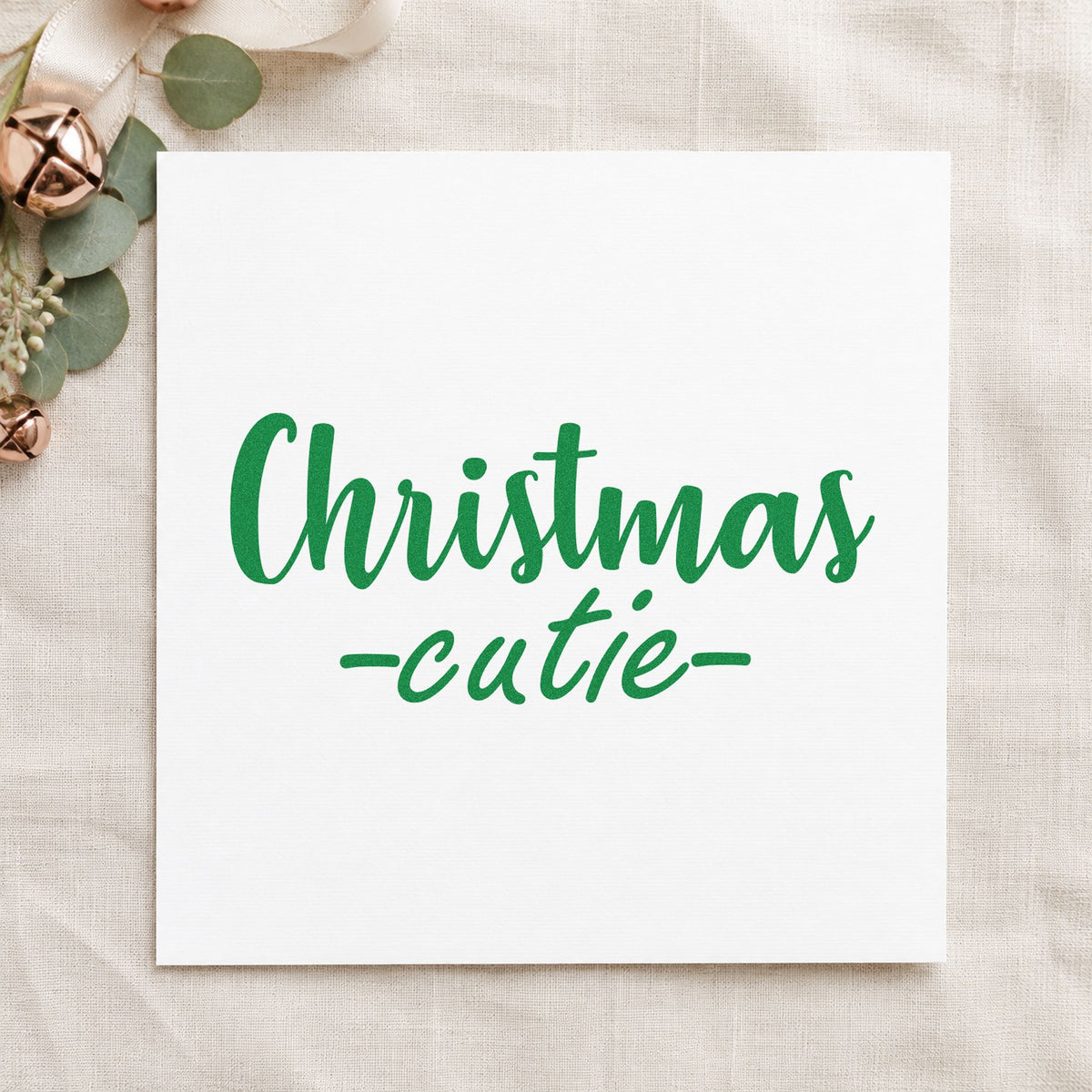 Christmas Cutie Script craft stamp imprinted in green ink on paper, a design suited to framed changing table.