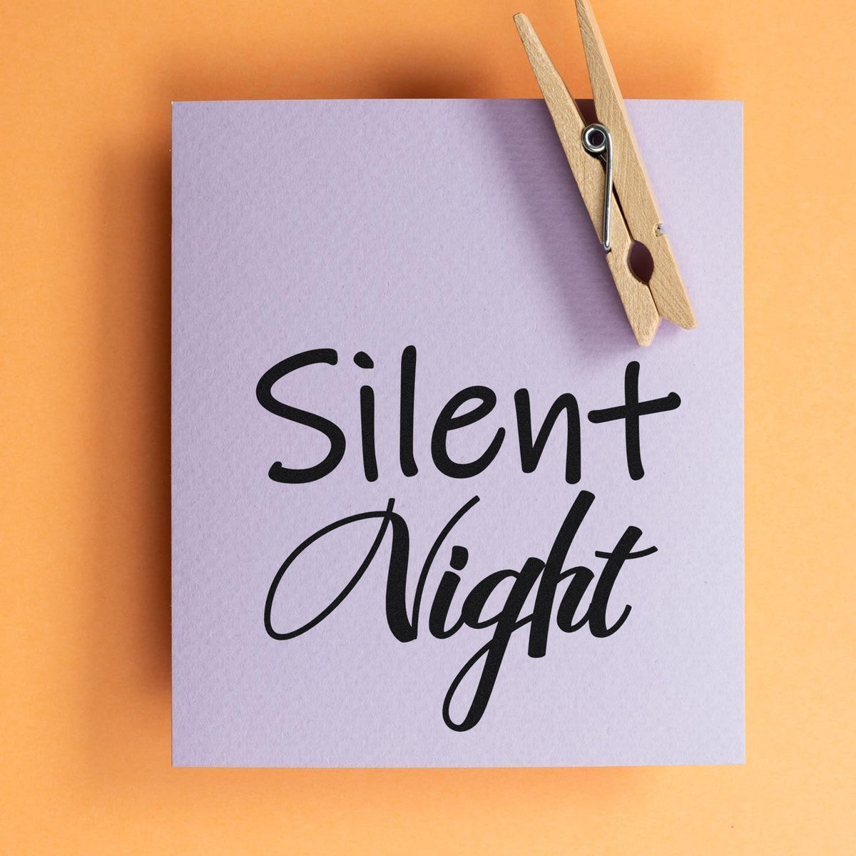 Silent Night holiday rubber stamp design on lavender paper with wooden clothespin