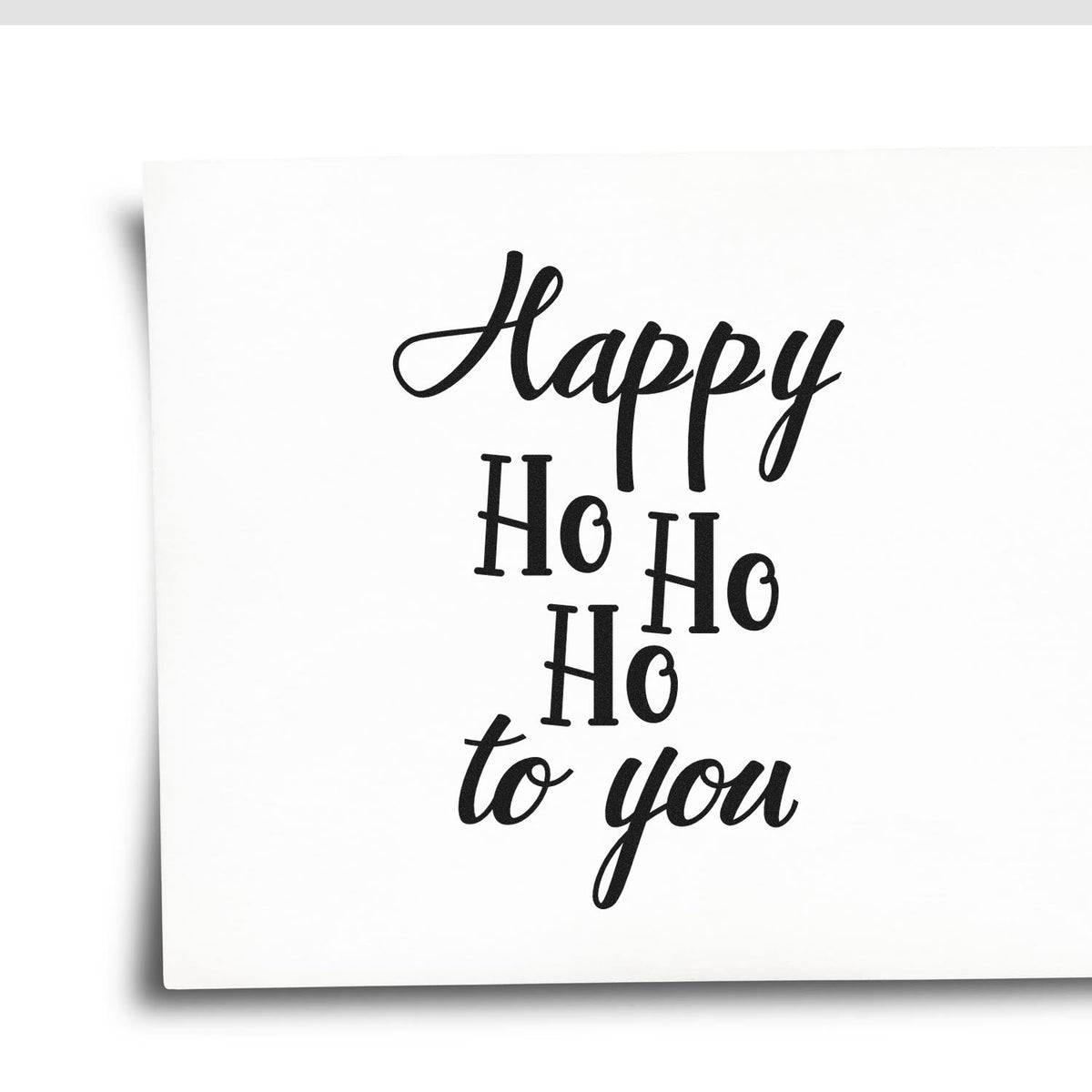 Happy Ho Ho Ho To You Pre-Inked Stamp – PSI imprint stamped in black ink. “Happy Ho Ho Ho to You” is arranged in a tall stack mixing script and serif letters.