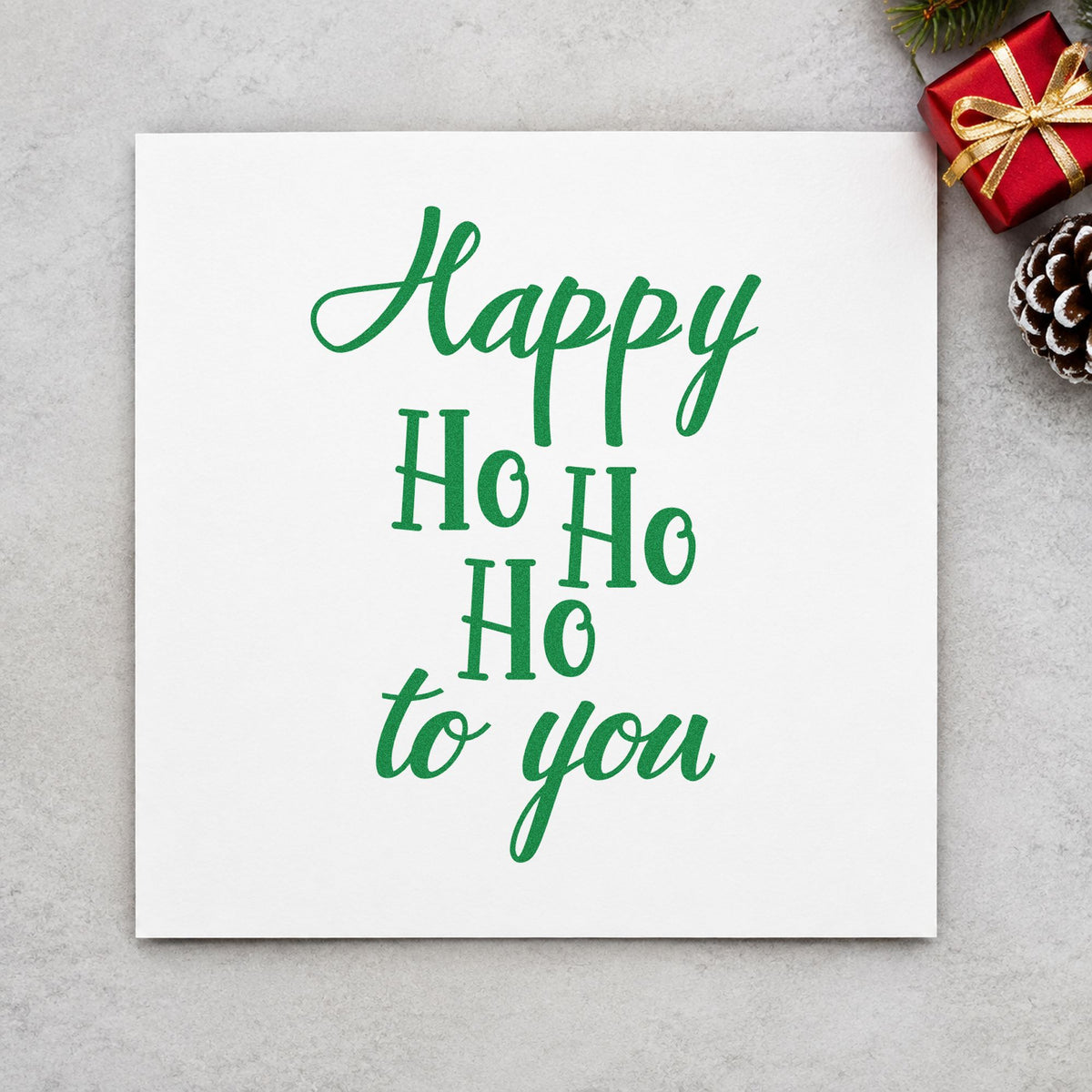 Happy Ho Ho Ho To You craft stamp imprint in green ink on a handmade project, one idea being door frame signs.