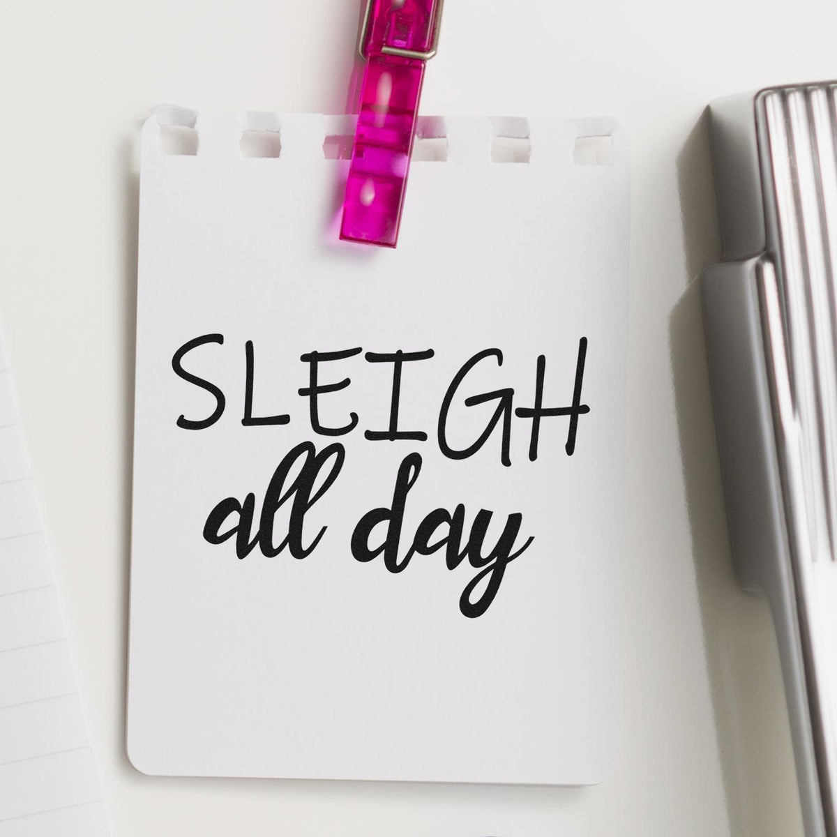 Holiday rubber stamp design reading Sleigh all day on a clipped note for festive cards, crafts, and planners.