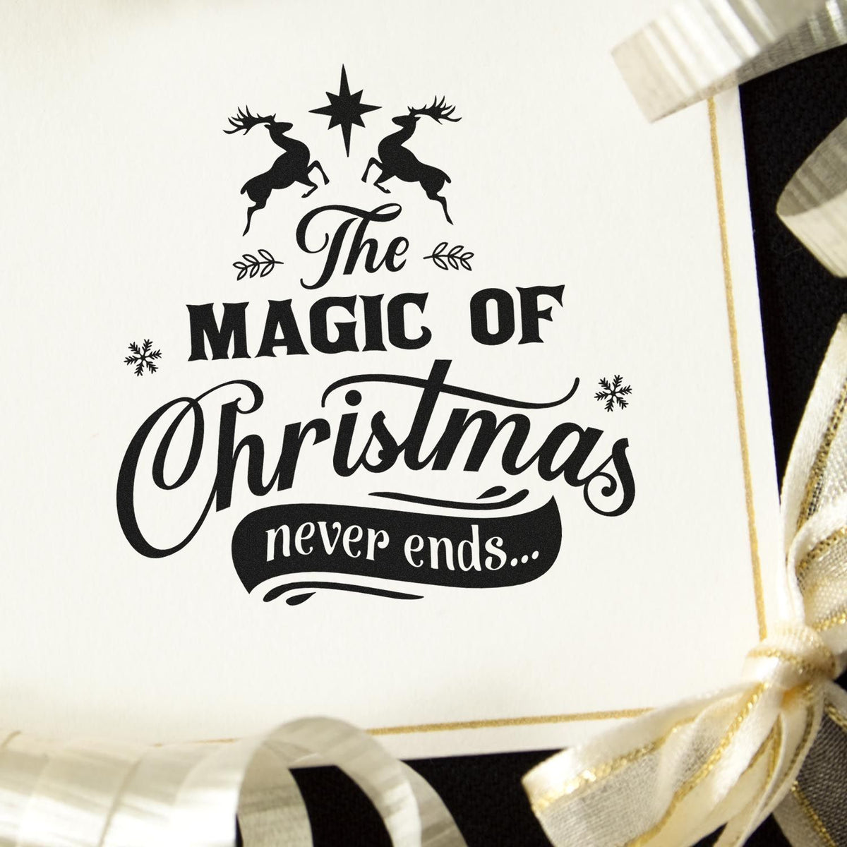 Holiday rubber stamp design reading The Magic of Christmas never ends with reindeer, star and festive Christmas card styling.