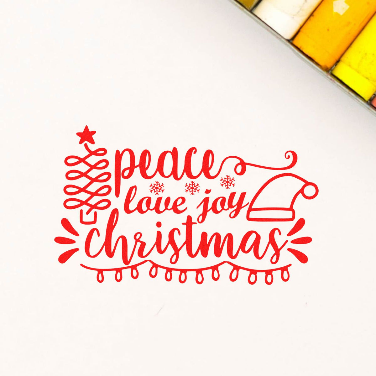 Red Christmas rubber stamp design with peace, love, and joy lettering, Santa hat, and holiday lights for card making.