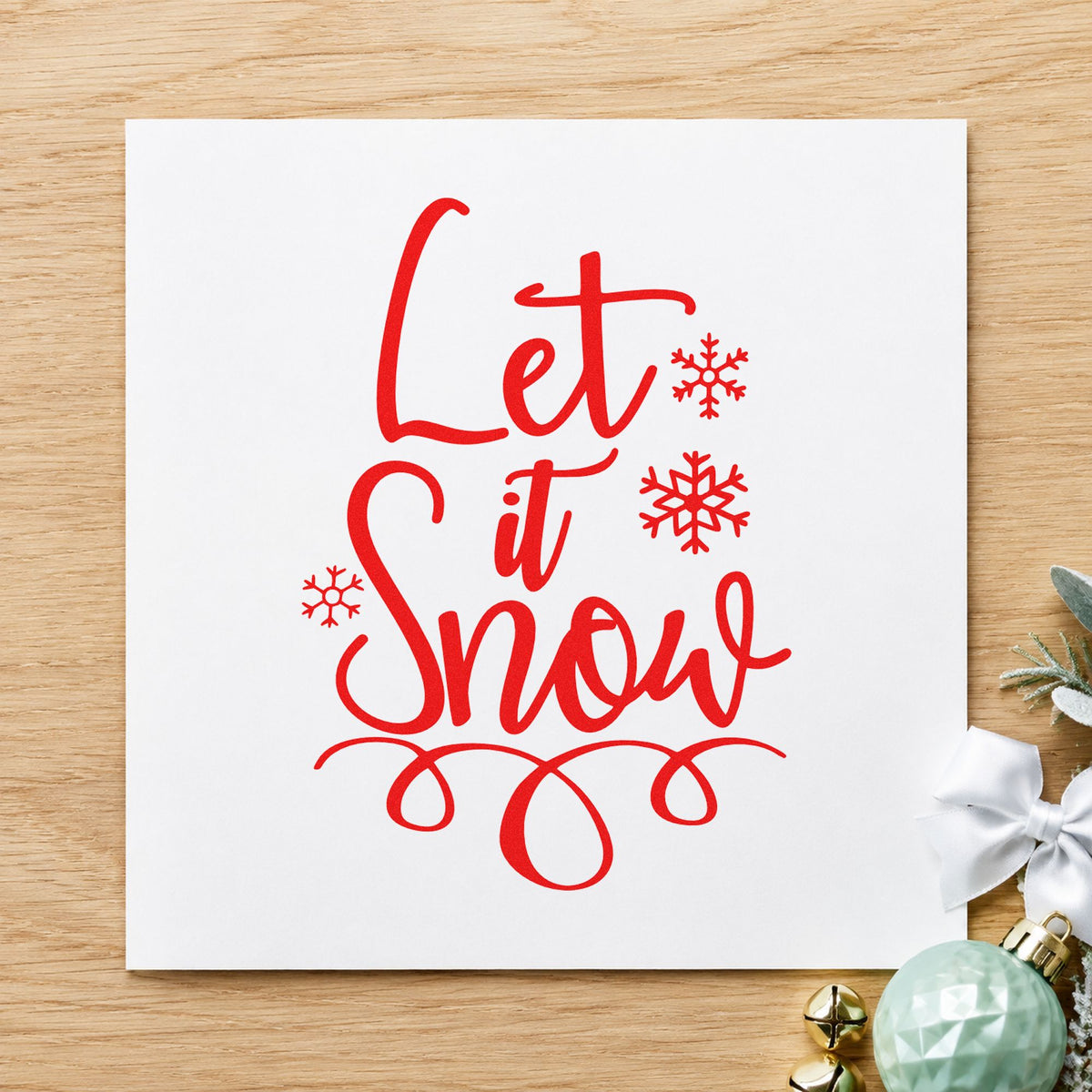 Let It Snow Loop Flourish craft stamp in red ink on cardstock, an easy option for work jacket printing.