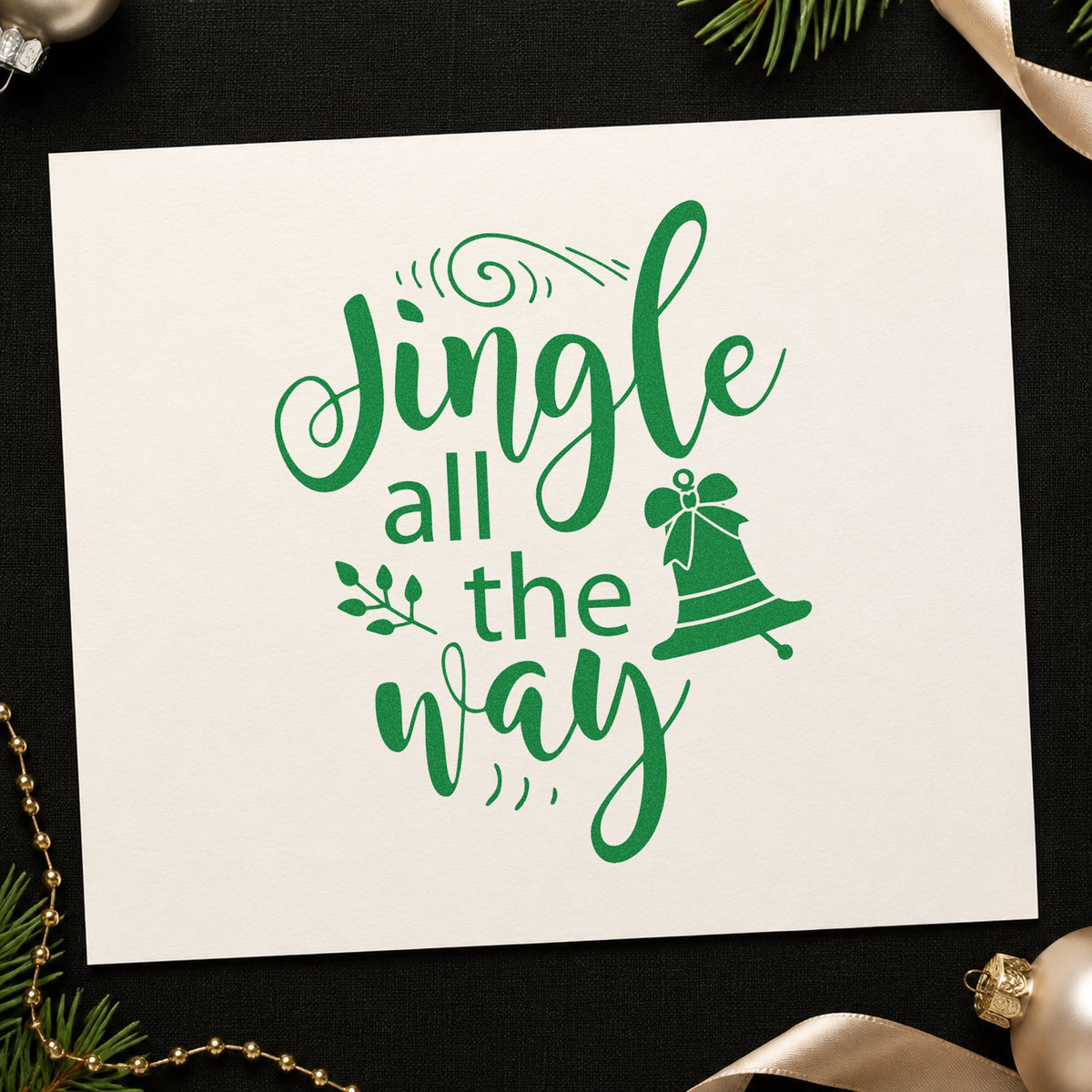 Jingle All The Way Bell craft stamp imprint in green ink on a handmade project, one idea being bell topper tags.