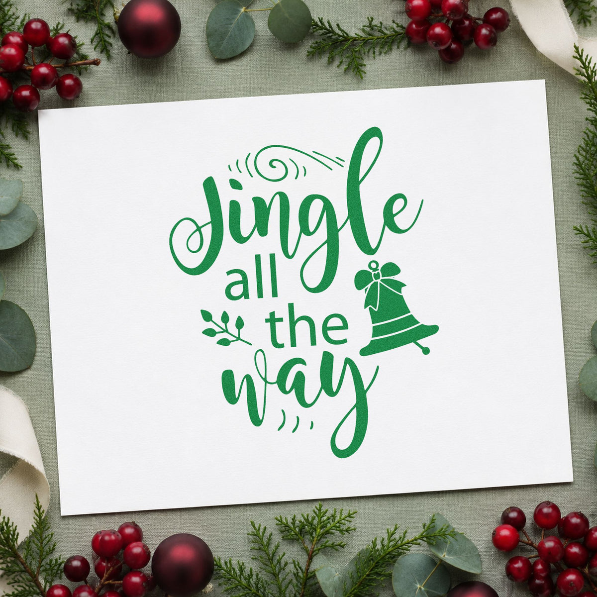 Jingle All The Way Bell craft stamp imprinted in green ink on paper, a design suited to framed wrap station.