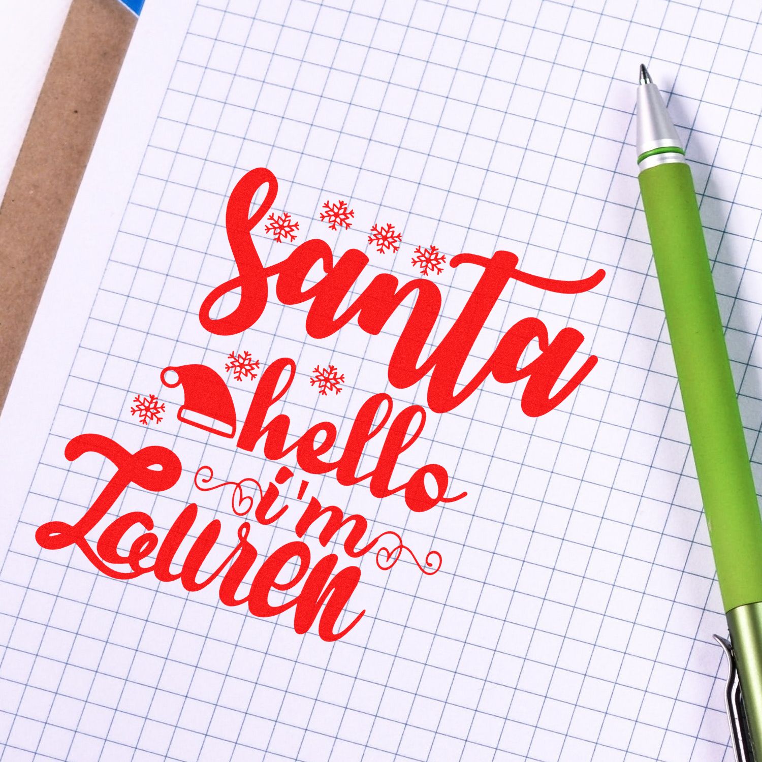 Custom Christmas rubber stamp design reading Santa, hello Im Lauren with snowflakes on graph paper.
