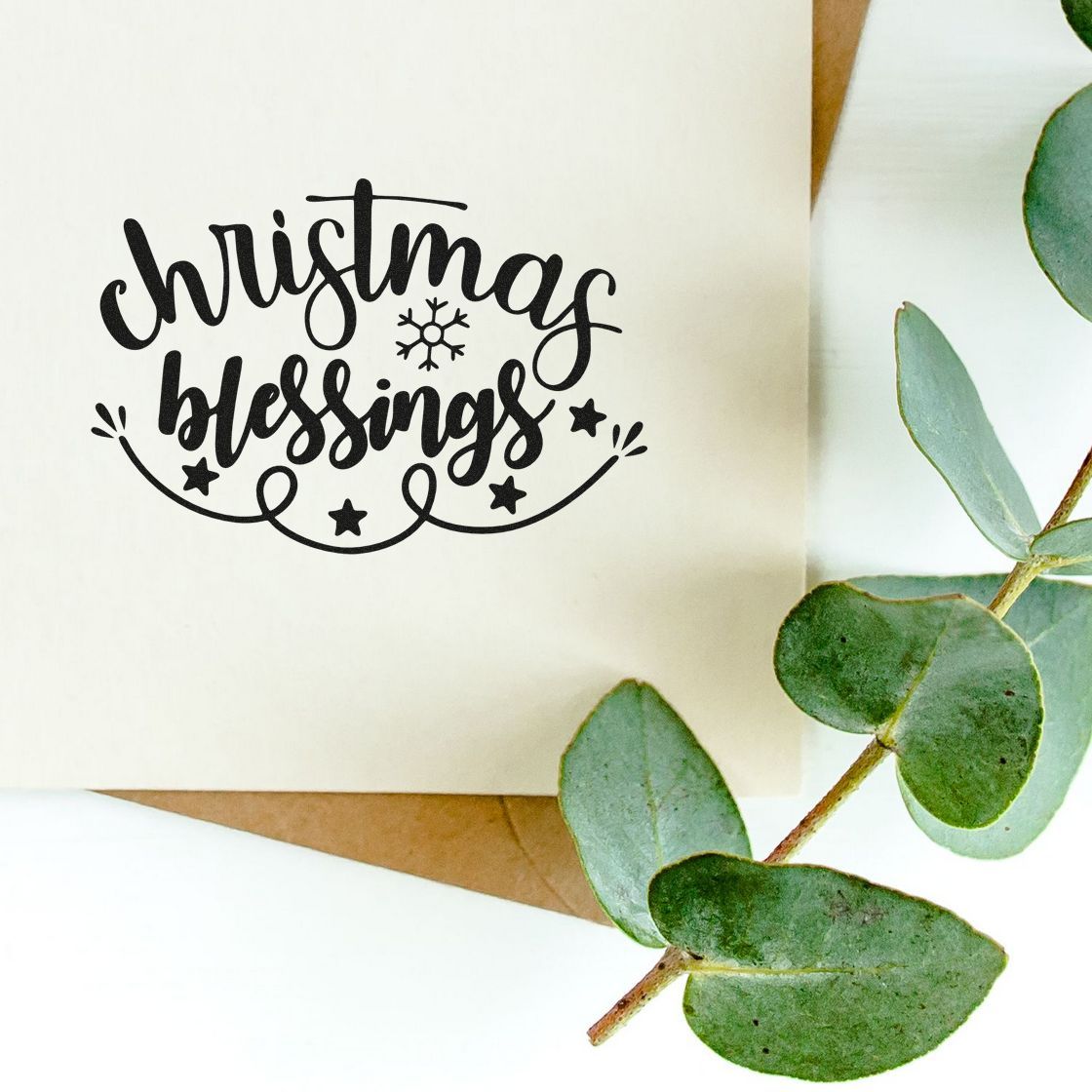Christmas blessings rubber stamp on greeting card with eucalyptus greenery, festive holiday handmade card design.