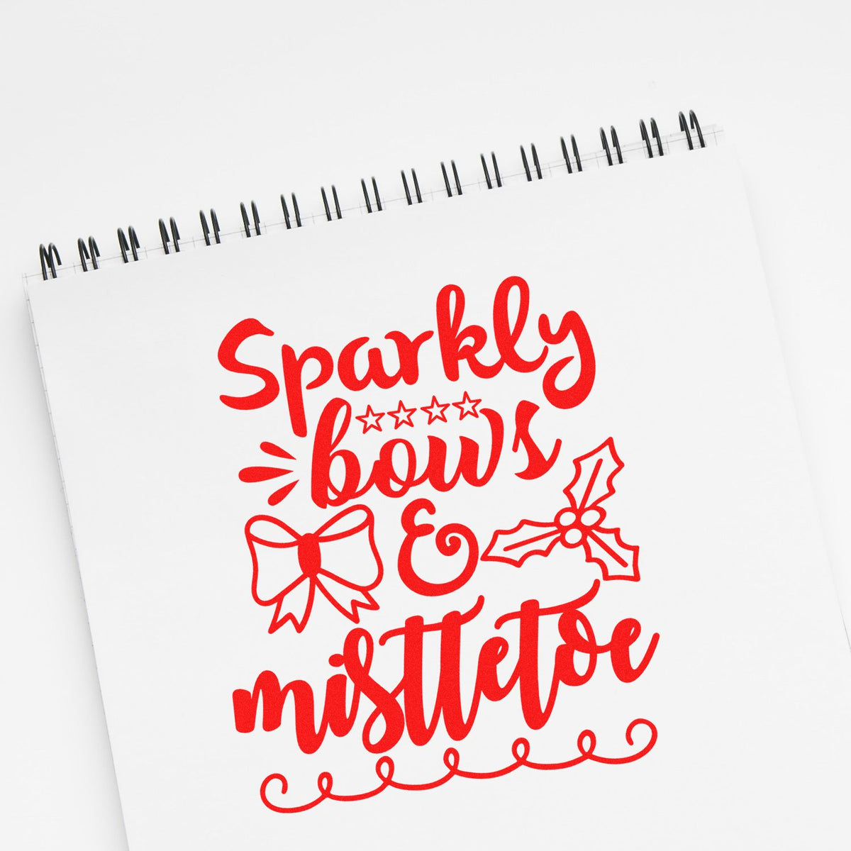 Sparkly bows and mistletoe rubber stamp design for holiday cards, featuring festive red lettering, bows, and mistletoe.