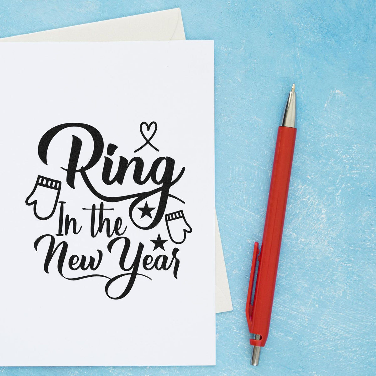 Ring in the New Year rubber stamp design for holiday cards, shown on white paper with a red pen.