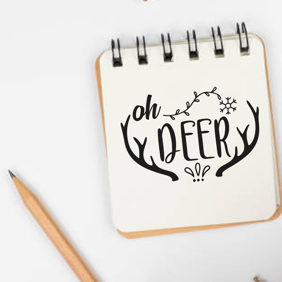 Oh deer rubber stamp design with antlers and snowflake, perfect for holiday cards, journaling, and winter crafts.