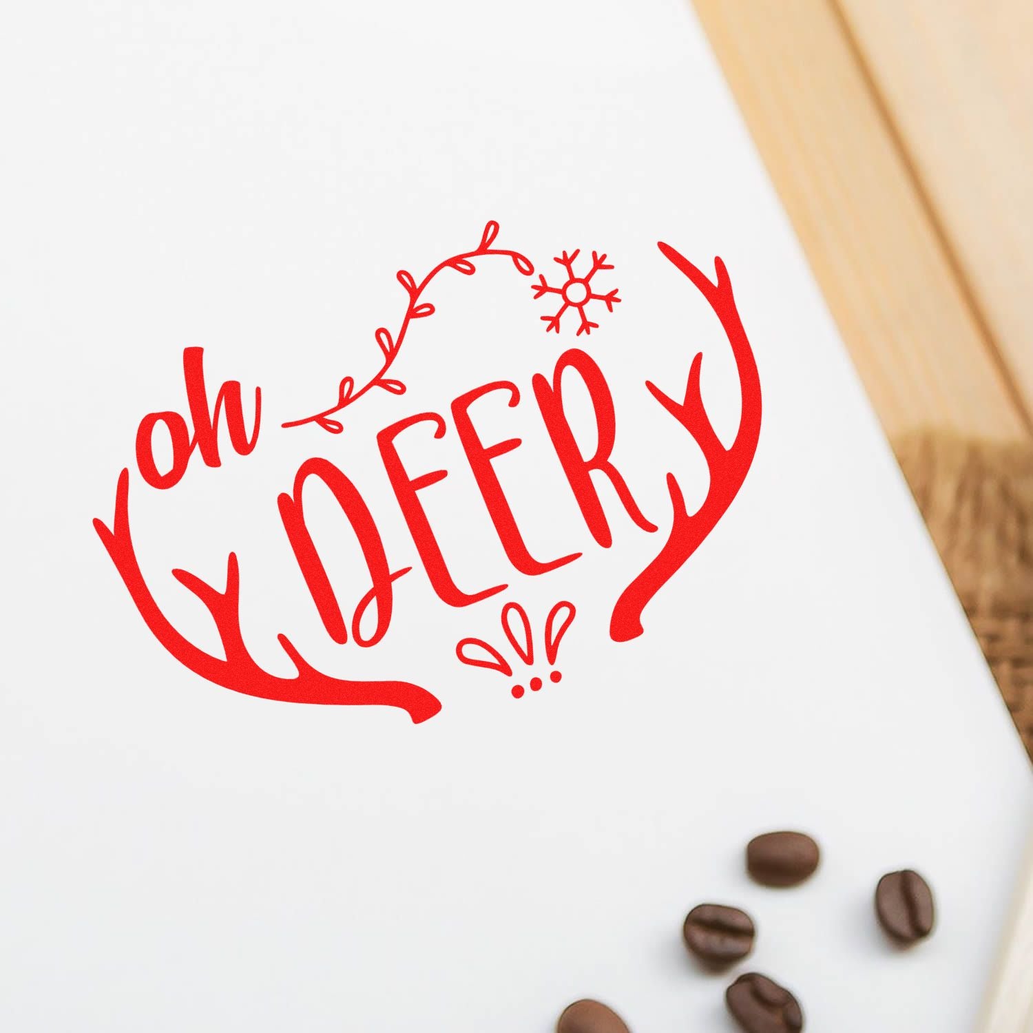 Red oh deer holiday rubber stamp design with antlers and snowflake on white paper, perfect for Christmas cards and crafts.