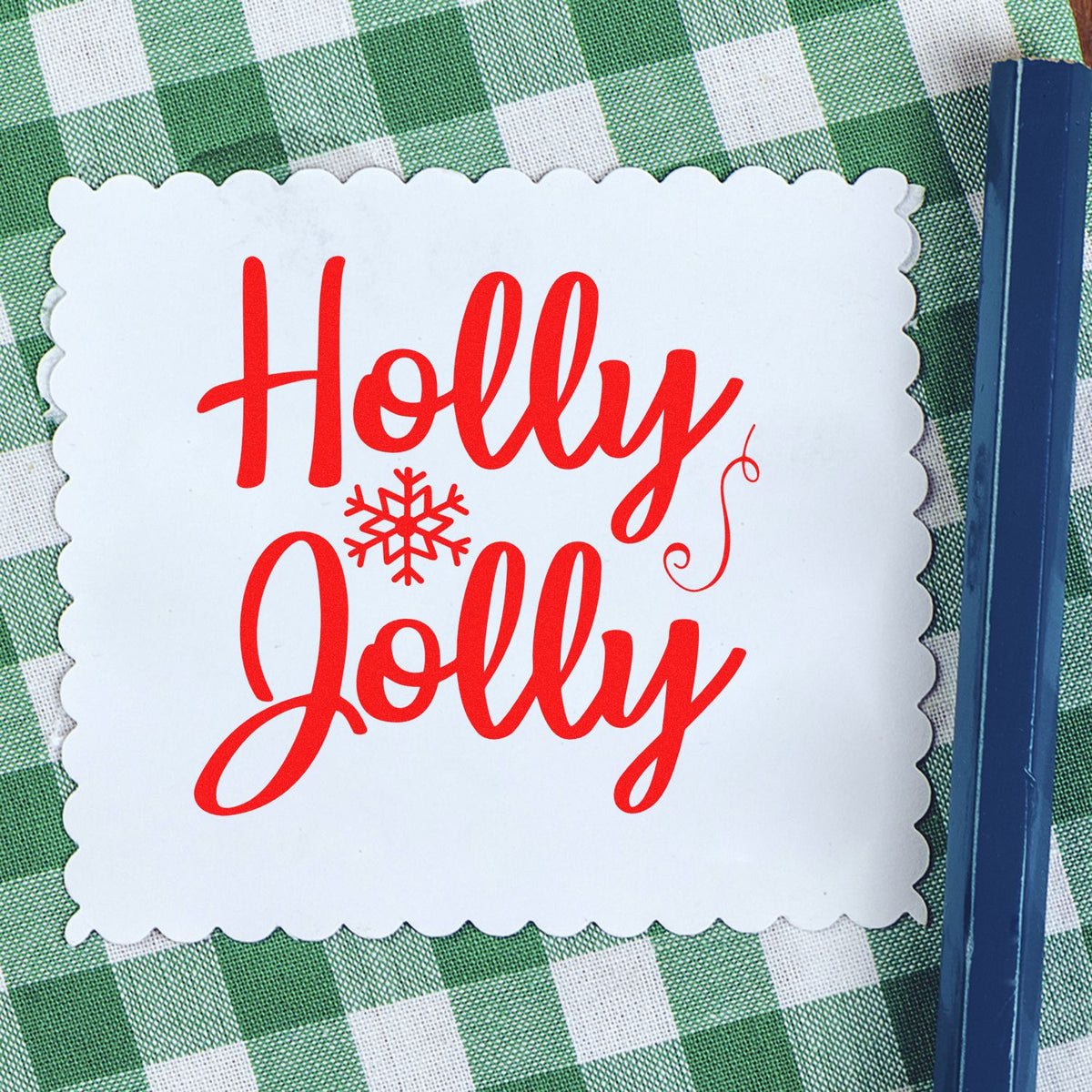 Holly Jolly Christmas rubber stamp design in red on white scalloped paper, ideal for holiday cards and festive crafts.