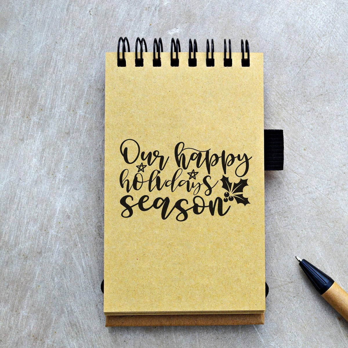 Our Happy Holidays Season Pre-Inked Stamp – PSI imprint stamped in blue ink. “Our Happy Holidays Season” appears in flowing script with holly and a small star.
