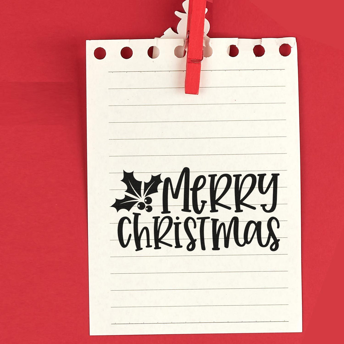 Merry Christmas rubber stamp design with holly on lined paper, ideal for festive holiday card making and scrapbooking.